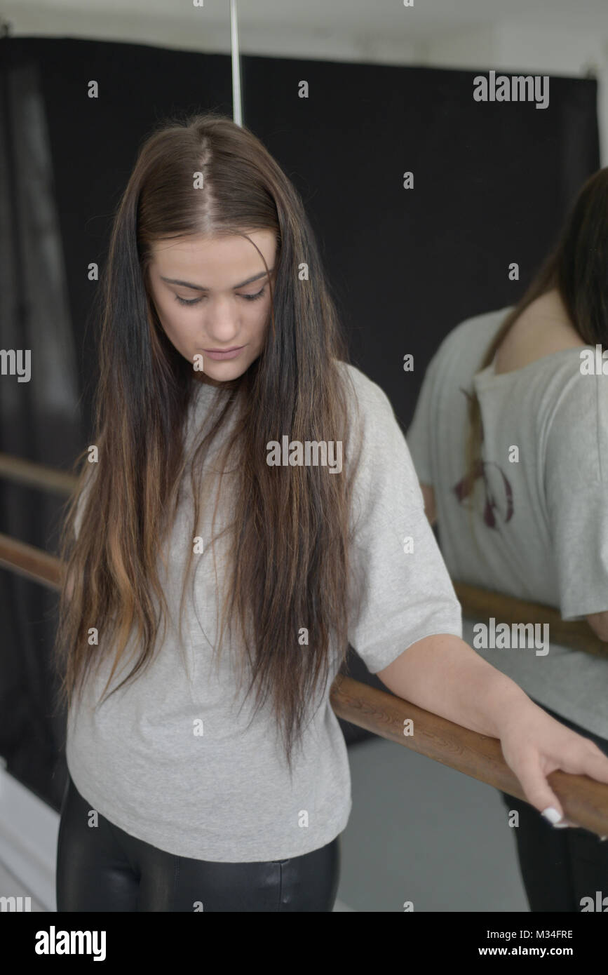 Portrait Of A Teenage Girl With Long Dark Hair Alone In A Room With A