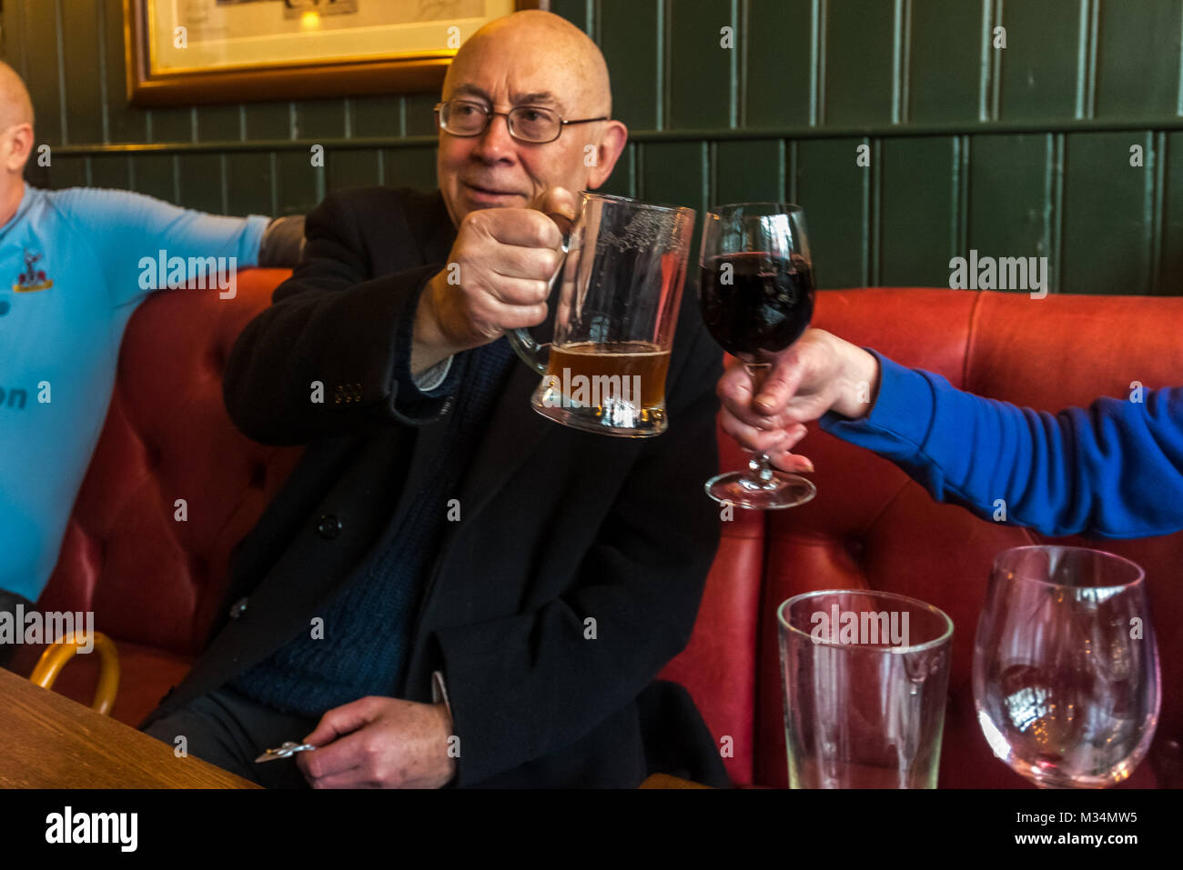 February 8, 2018 - London, UK. 8th February 2018. Ian Bone celebrates in the pub opposite the High Court after stopping an attempt by lawyers acting for the Qatari royal family to prevent a Class War protest against the ten empty Â£50million pound apartments in The Shard. They had tried to get an injunction against protests by Bone and ''persons unknown'' and to claim over Â£500 in legal costs from the 70 year-old south London pensioner, but had then offered to drop the case if Class War 'would stop attacking the Shard'. Their attempt to stifle protest was covered in national and international Stock Photo