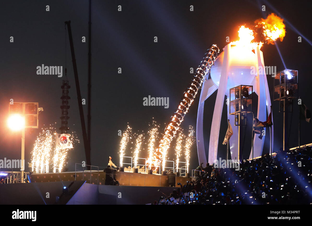 Pyeongchang, South Korea. 9th Feb, 2018. The Olympic flame is lit by Jong Su Hyon from North Korea and Park Jong-ah from South Korea at the opening ceremony of the Winter Olympics in Pyeongchang, South Korea, 9 February 2018. Credit: Michael Kappeler/dpa/Alamy Live News Stock Photo