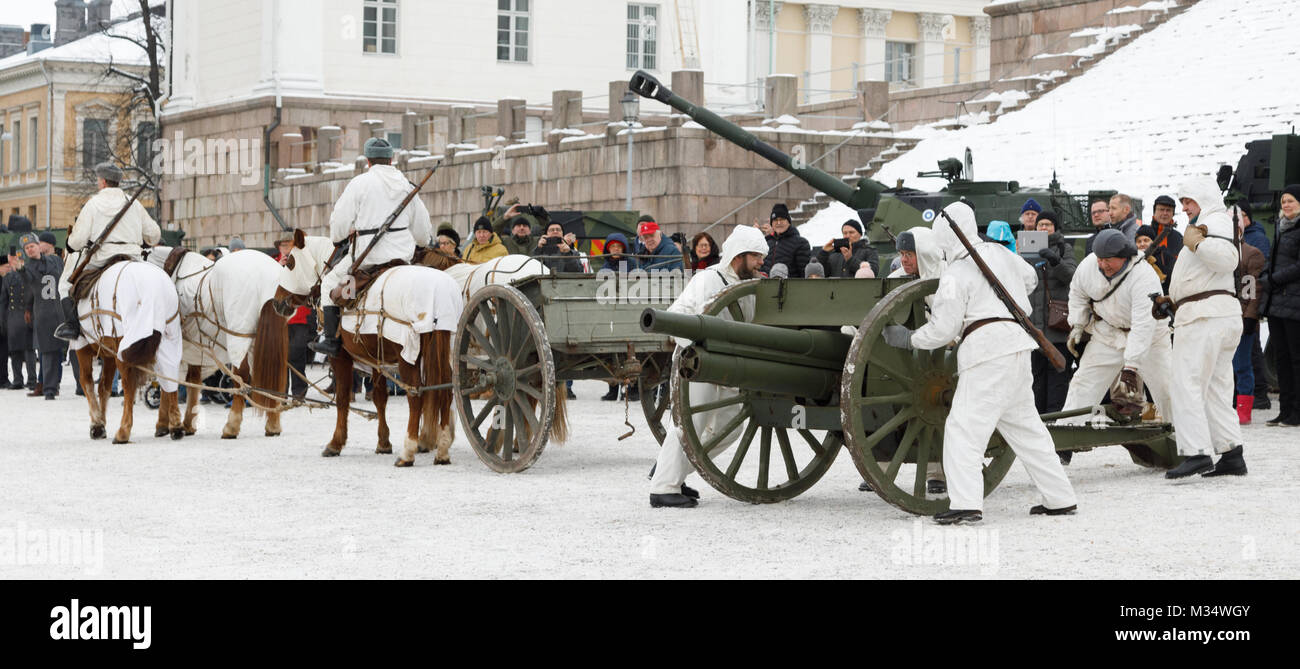 Helsinki, Finland. 8th Feb, 2018. To commemorate the 100 years history of artillery in independent Finland, a public event was arranged at the Senate Square of Helsinki on 9 February 2018. There was a display of present-day equipment, plus a re-enactment of a horse-driven field artillery piece driven into a firing position. The horses as well as the firing crew are wearing white snow camouflage, as in the days of the Winter War 1939-40. Credit: Hannu Mononen/Alamy Live News Stock Photo