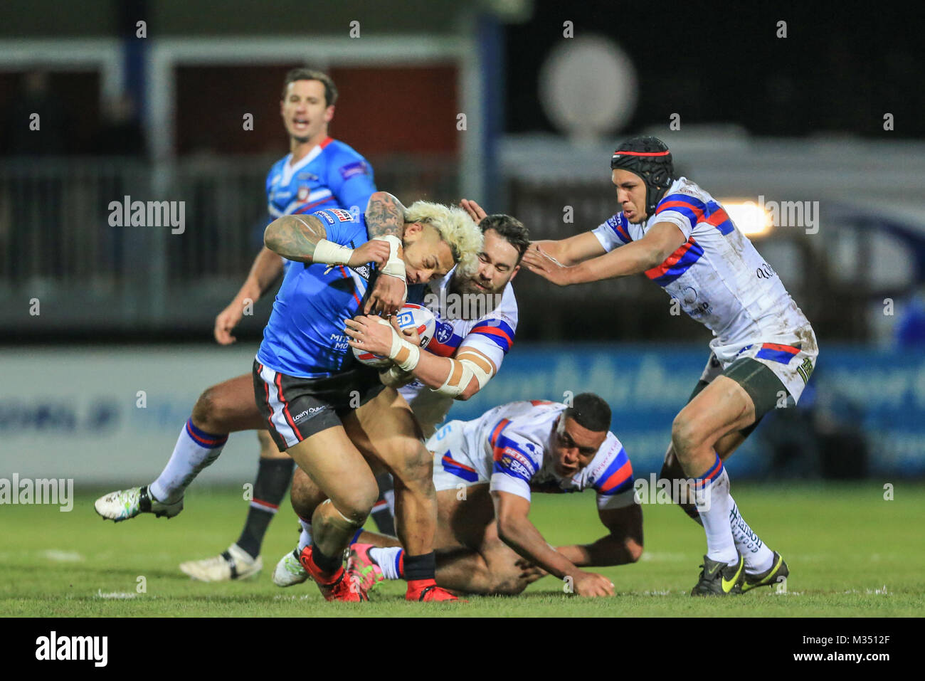 Junior Sa'u of Salford Red Devils is tackled by Craig Huby of Wakefield Trinity during the Betfred Super League Round 2 Wakefield versus Salford Red Devils 09/02/2018 at the Mobile Rocket Stadium Stock Photo