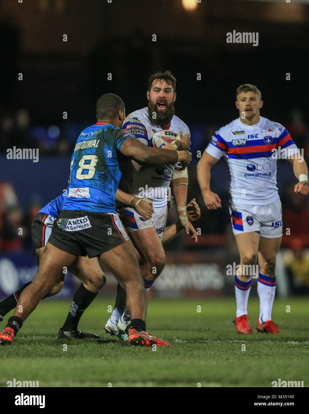 Craig Huby of Wakefield Trinity is tackled by Ben Nakubuwai of Salford Red Devils during the Betfred Super League Round 2 Wakefield versus Salford Red Devils 09/02/2018 at the Mobile Rocket Stadium Stock Photo