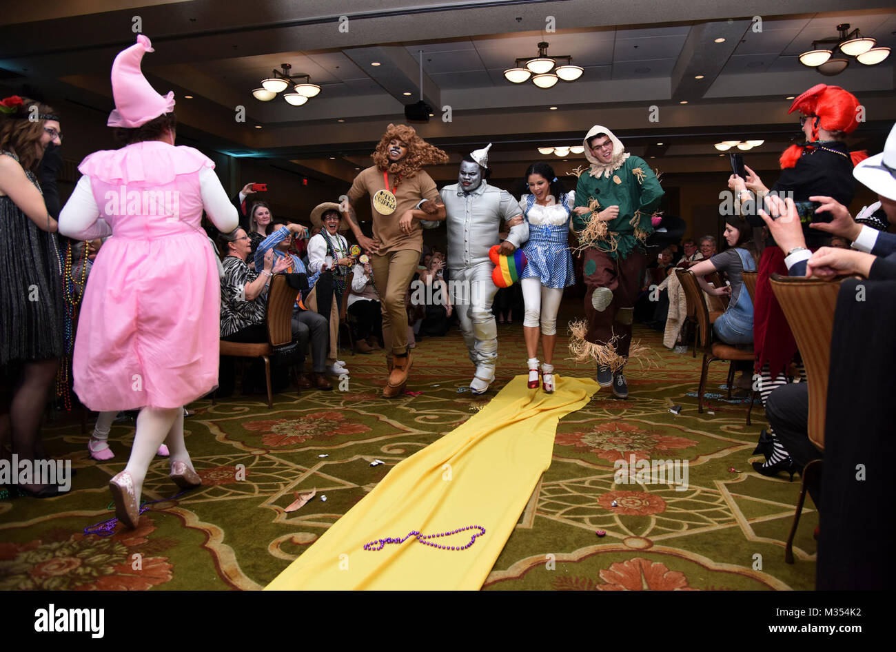 Members of the 81st Medical Operations Squadron portray the cast of The Wizard of Oz as they dance down the aisle during a Mardi Gras float contest at the 30th Annual Krewe of Medics Mardi Gras Ball at the Bay Breeze Event Center Feb. 3, 2018, on Keesler Air Force Base, Mississippi. The Krewe of Medics hosts a yearly ball to give Keesler Medical Center personnel a taste of the Gulf Coast and an opportunity to experience a traditional Mardi Gras. The theme for this year's ball was Read It-Be It. The 81st MDOS won first place in the float contest. (U.S. Air Force Stock Photo