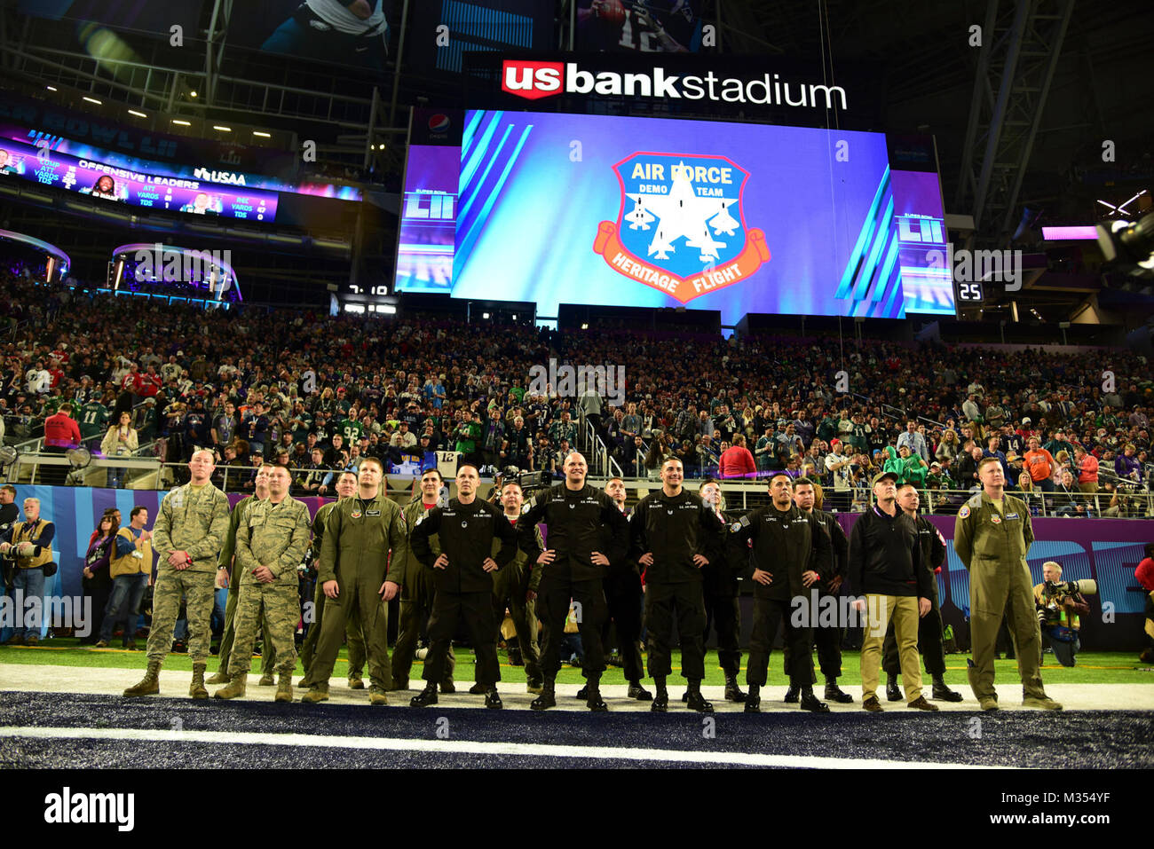 U.S. Air Force Airmen from the F-16 Viper Demonstration Team, A-10C Thunderbolt II Demonstration Team, and the Air Combat Command Aerial Control Team are recognized on the field during Super Bowl 52 at U.S. Bank Stadium in Minneapolis, Minn., Feb. 4th, 2018. ACC Aerial events coordinated a Heritage Flight flyover during the opening ceremonies of the game that both the demo teams and the Air Force Heritage Flight Foundation supported. (U.S. Air Force Stock Photo