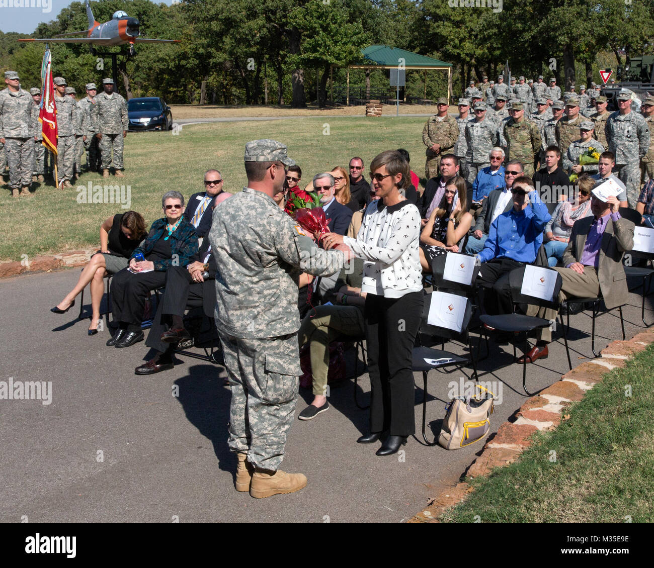 Flowers are presented to Mrs. Wilham, wife of outgoing commander Col