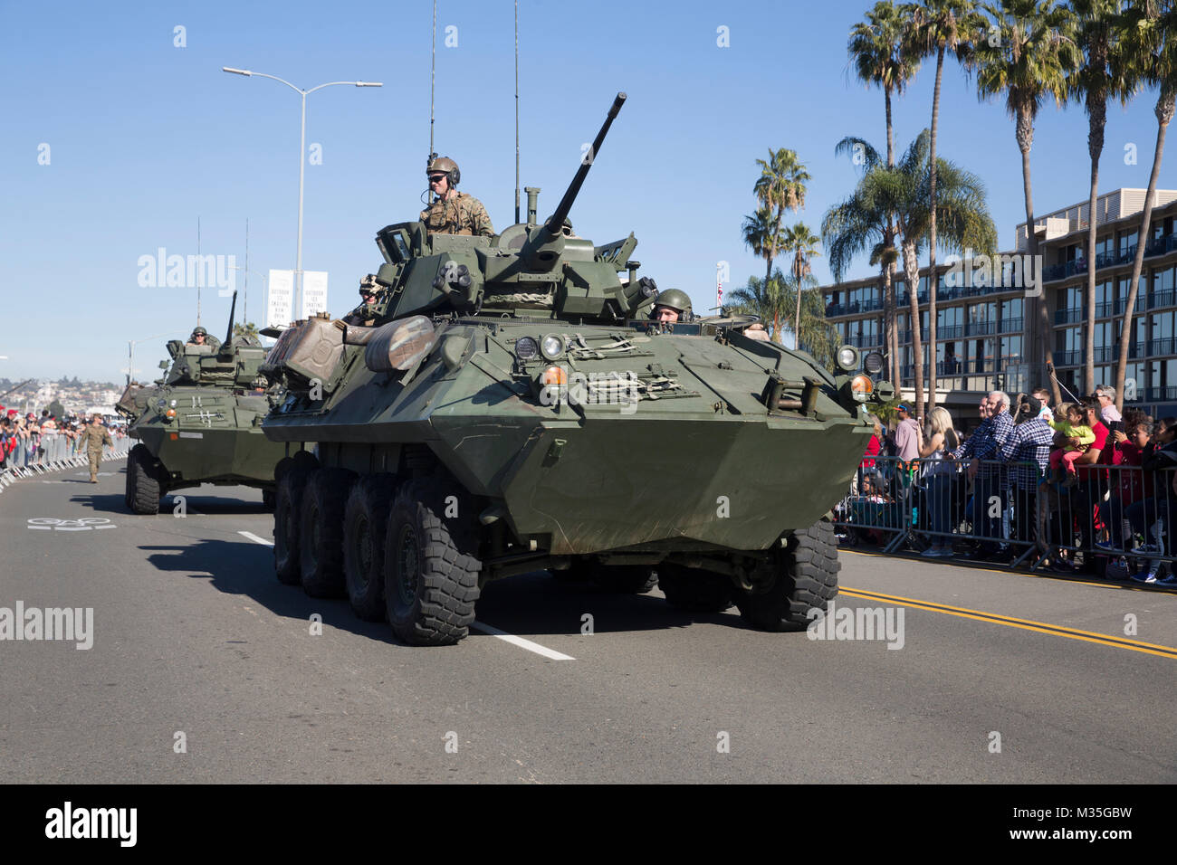 SAN DIEGO, Calif. – Marines with I Marine Expeditionary Force drive light armored vehicles by cheering crowds during the San Diego County Credit Union Holiday Bowl Parade, in San Diego, Dec. 28, 2017. In 2017, I MEF Marines and Sailors supported more than 140 community events. (U.S. Marine Corps photo by Lance Cpl. Cutler Brice) Stock Photo