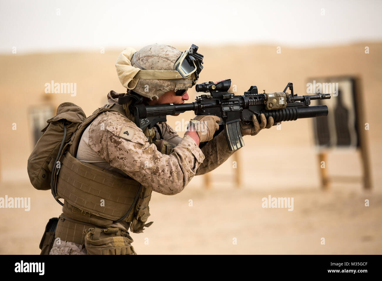 U.S Marine Cpl. Owen Silas, Headquarters and Service Company, Ground Combat Element, Special Purpose Marine Air-Ground Task Force – Crisis Response – Central Command, fires his weapon during a combat marksmanship program live-fire range, Jan. 23, 2018. The purpose of the training was to increase lethality, solidify warrior ethos, and shoot in a variety of conditions. Stock Photo
