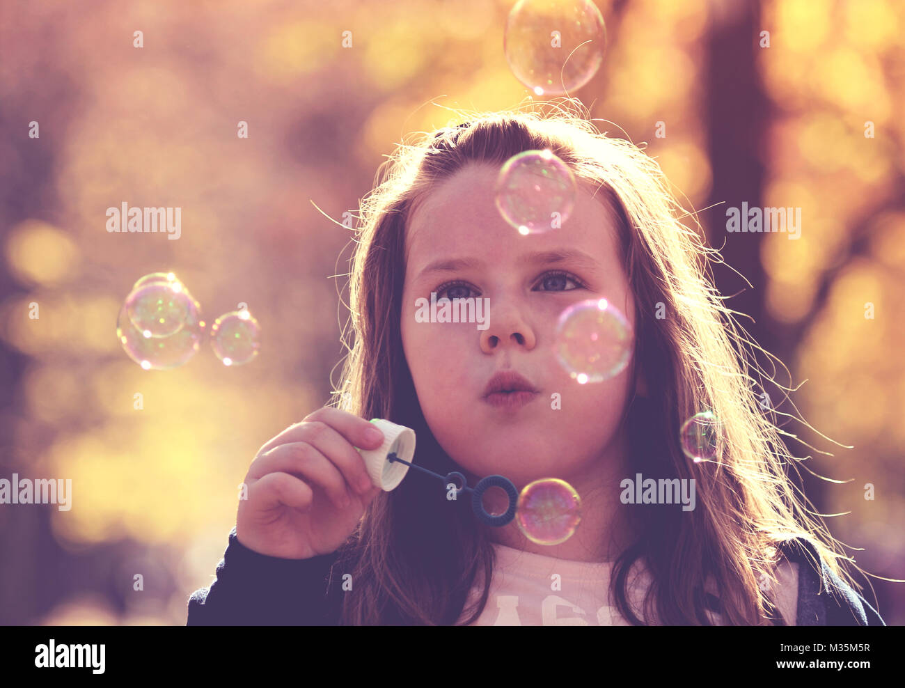 Little girl making soap bubbles Stock Photo Alamy