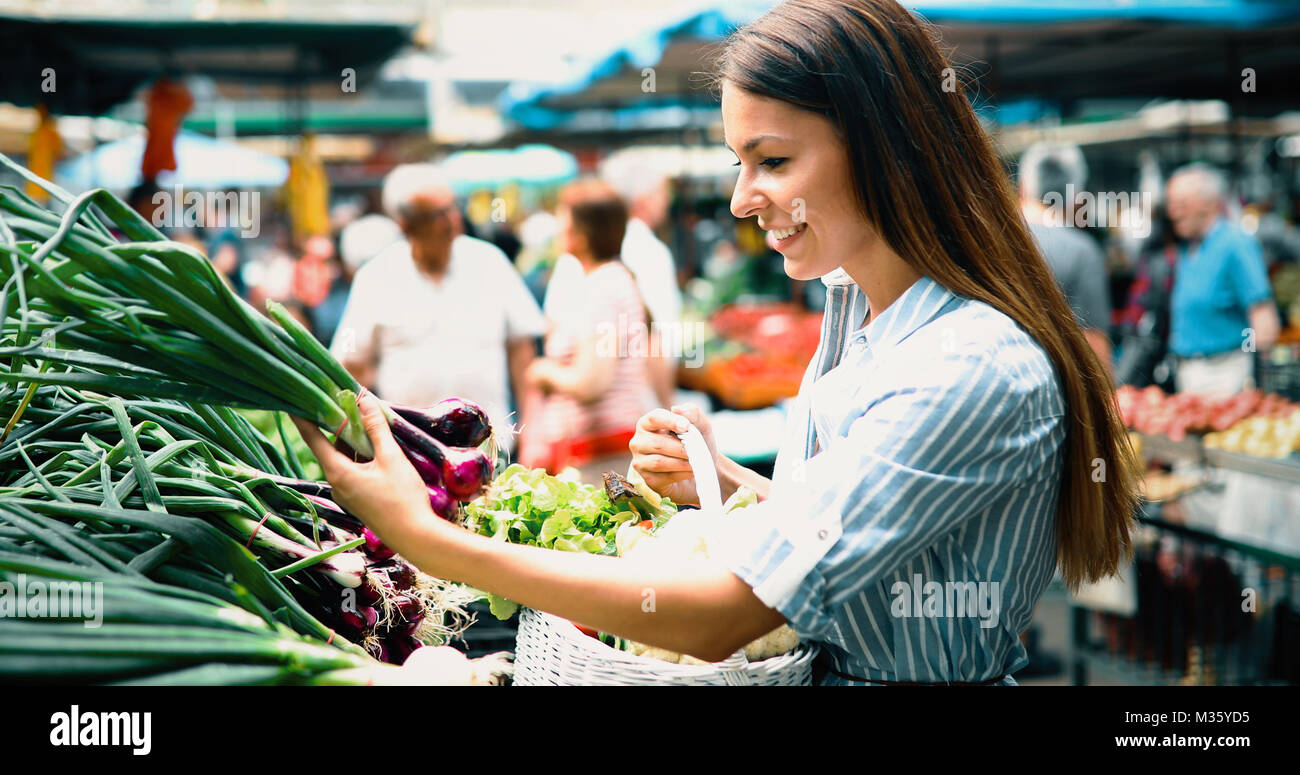 Portrait of beautiful woman holding shopping basket Stock Photo - Alamy
