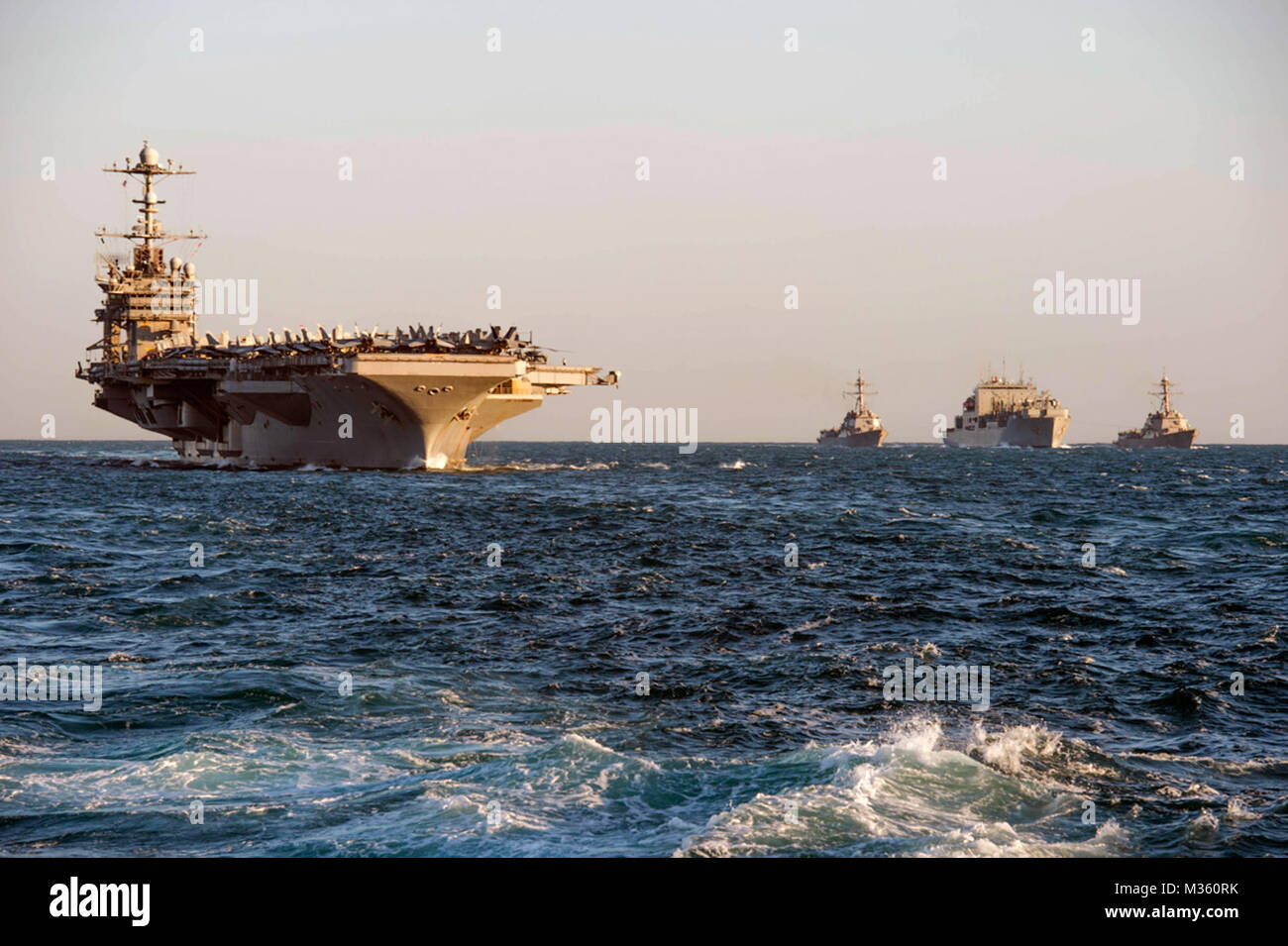 150719-N-XM324-108 TIMOR SEA (July 19, 2015) (from left to right) Nimitz-class aircraft carrier USS George Washington (CVN 73), Arleigh Burke-class guided-missile destroyer USS Mustin (DDG 89), dry cargo ship USNS Washington Chambers (T-AKE 11), and Arleigh Burke-class guided-missile destroyer USS Chafee (DDG 90) conduct a replenishment at sea. (U.S. Navy photo by Mass Communication Specialist 3rd Class Patrick Dionne/Released) USS George Washington Conducts Replenishment at Sea by #PACOM Stock Photo