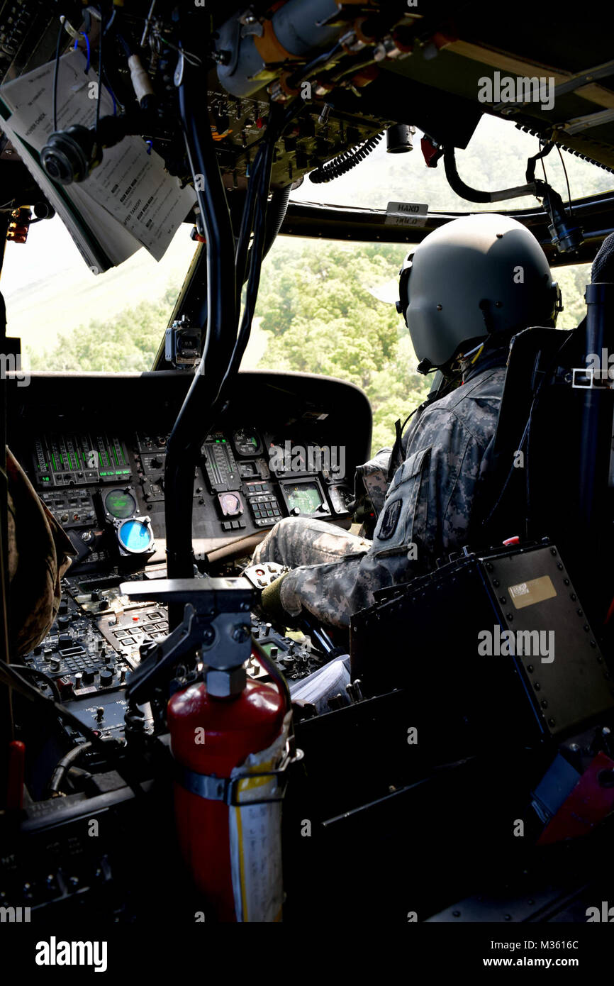 FORT STEWART, Ga., July 25, 2015 - A UH-60 Black Hawk assigned to Charlie Company 1st Battalion 185th Aviation Regiment makes a hard right turn over Fort Stewart, Ga.  Georgia Army National Guard photo by Capt. William Carraway / released Bank Right by Georgia National Guard Stock Photo