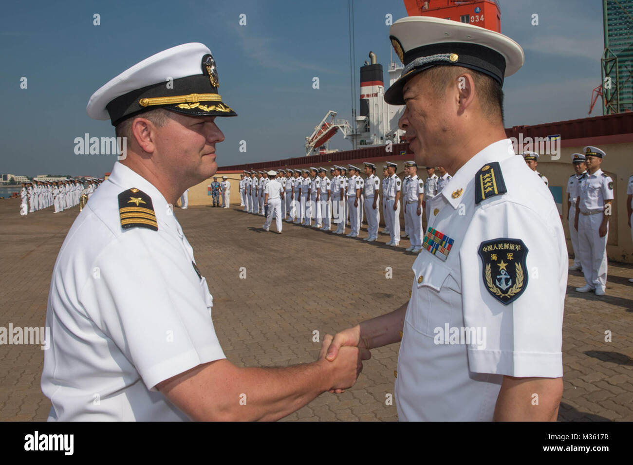 150730-N-UF697-057  QINGDAO, China (July 30, 2015) Cmdr. Harry Marsh, left, commanding officer of the Arleigh Burke-class guided-missile destroyer USS Stethem (DDG 63), bids farewell to Peoples Liberation Army Navy Senior Capt. Jin Wei, director of the General Office of the North Sea Fleet, after a port visit to Qingdao, China. The purpose of the port call in Qingdao is to continue to build key diplomatic and military relationships and to illustrate the U.S. Navy’s commitment to broadening ties in the Indo-Asia-Pacific region. (U.S. Navy photo by Mass Communication Specialist 3rd Class Kevin V Stock Photo