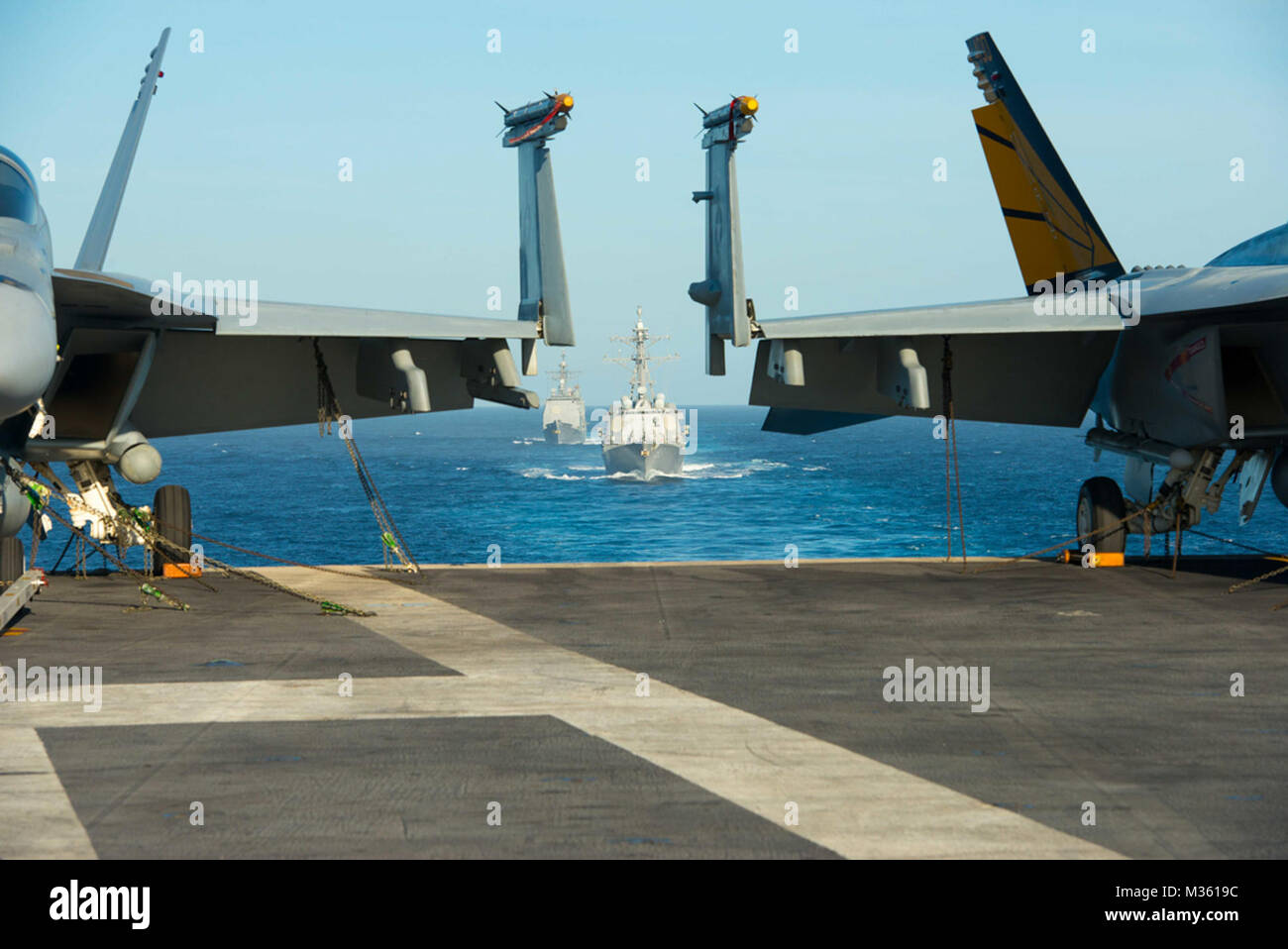 150804-N-YZ901-033  PACIFIC OCEAN (Aug. 4, 2015) The guided-missile destroyer USS Chung Hoon (DDG 93) and the guided-missile cruiser USS Mobile Bay (CG 53) transit behind the aircraft carrier USS John C. Stennis (CVN 74) during a show of force exercise. The John C. Stennis Strike Group is participating in a composite training unit exercise, the final step before being certified for deployment. (U.S. Navy photo by Mass Communication Specialist 2nd Class Christian B. Martinez/ Released) John C. Stennis Strike Group Conducts Composite Training Unit Exercise in the Pacific Ocean by #PACOM Stock Photo