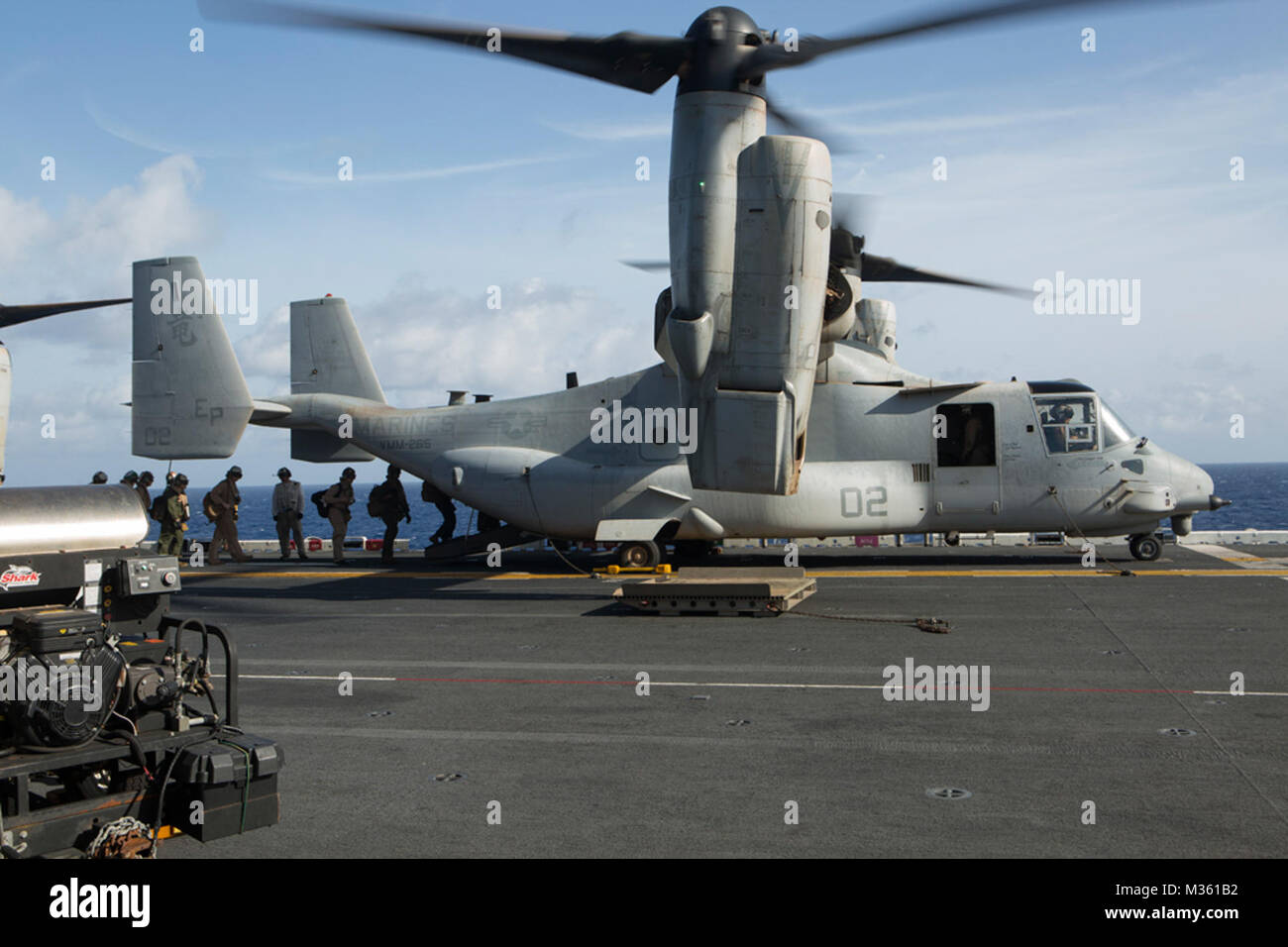 U.S. Marines and sailors with the 31st Marine Expeditionary Unit load into an MV-22B Osprey aboard the USS Bonhomme Richard (LHD 6), Aug. 8, 2015. The 31st MEU is staging Ospreys in Guam in support of typhoon recovery efforts in Saipan. The aircraft will be on standby in the event their aerial lift capacity is needed to distribute emergency supplies to remote areas. Saipan, the most populated island in the Commonwealth of the Northern Mariana Islands, was struck by Typhoon Soudelor Aug. 2-3.  (U.S. Marine Corps photo by Cpl. Tyler Ngiraswei/ Released) Marines Assist Saipan During Typhoon Recov Stock Photo