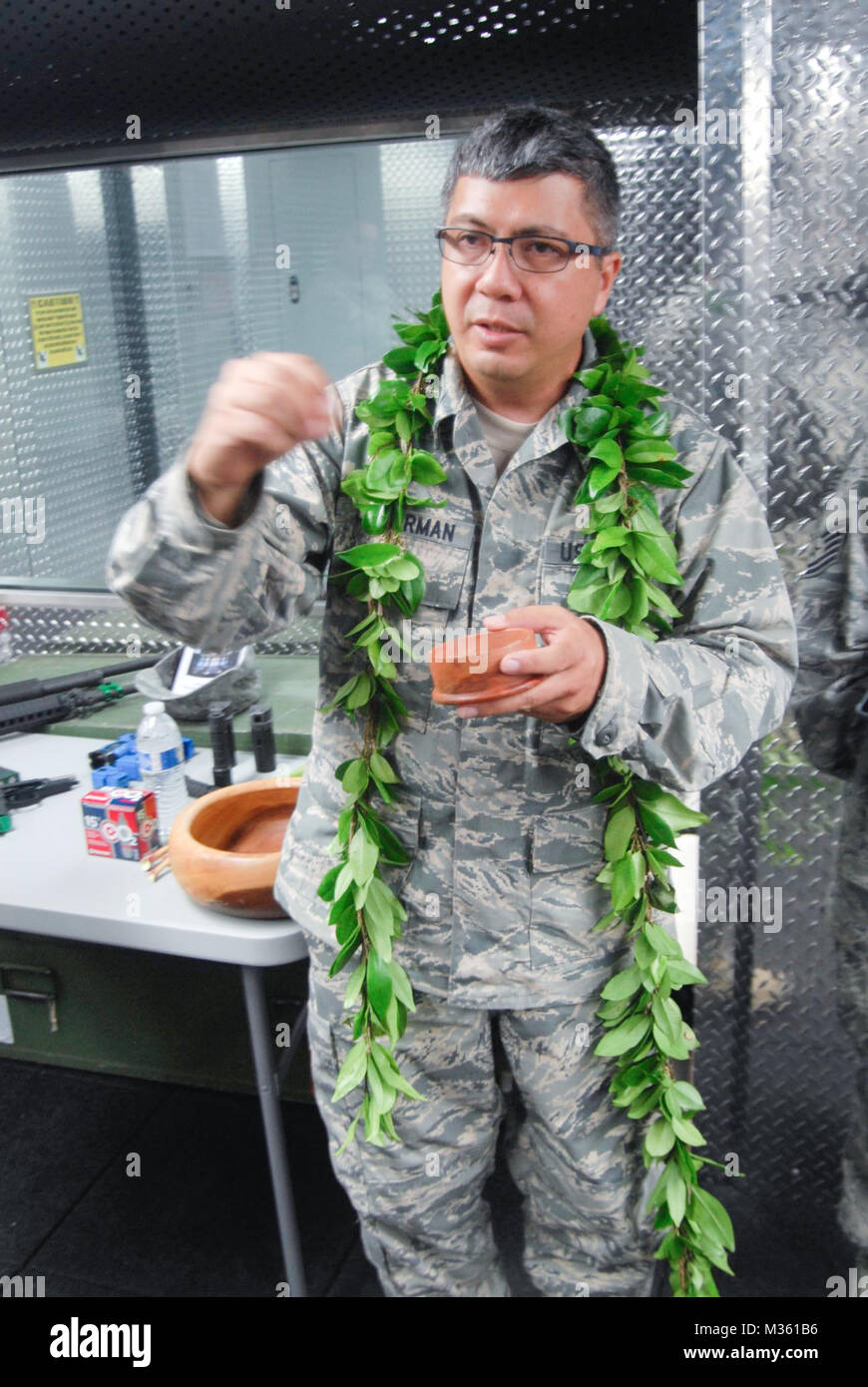 U.S. Air Force Chaplain Daniel Leatherman, 154 Wing Headquarters, performs a blessing at the 154 Security Forces Squadron (SFS) Indoor Firing Range on Joint Base Pearl Harbor-Hickam, Hawaii, Aug. 8, 2015. Salt is spread throughout the facility by the Chaplain and members of the 154 SFS as a way to purify and protect the facility. (U.S. Air National Guard photo by Airman 1st Class Robert Cabuco) 150808-Z-UW413-005.jpg by Hawaii Air National Guard Stock Photo