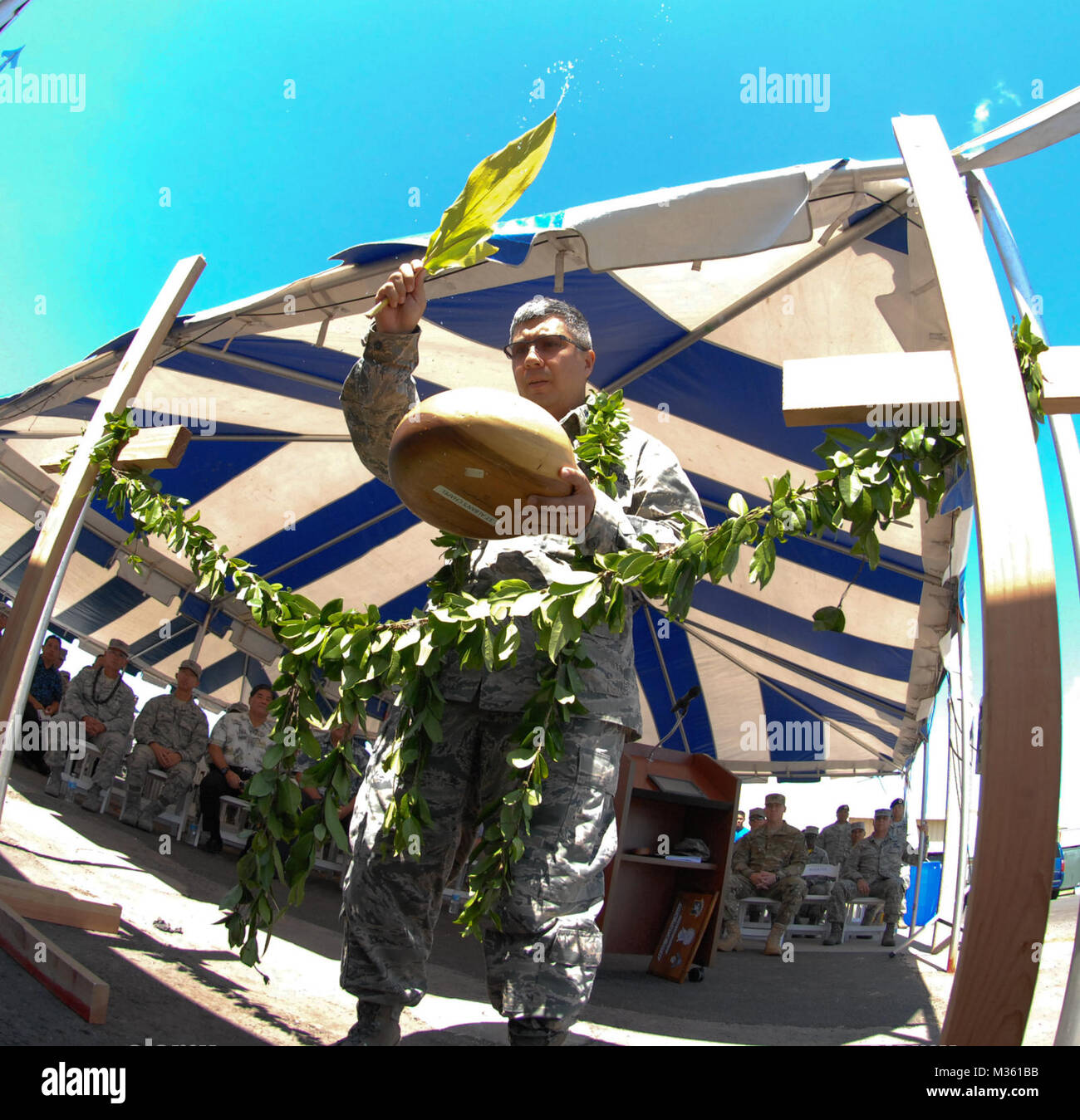 U.S. Air Force Chaplain Daniel Leatherman, 154 Wing Headquarters, performs a blessing at the 154 Security Forces Squadron (SFS) Indoor Firing Range on Joint Base Pearl Harbor-Hickam, Hawaii, Aug. 8, 2015. The Hawaiian tradition of unraveling of the maile lei, a native Hawaiian vine with shiny fragrant leaves, is similar to a typical ribbon cutting ceremony performed at the entrance of the new facility. (U.S. Air National Guard photo by Airman 1st Class Robert Cabuco) 150808-Z-UW413-028.JPG by Hawaii Air National Guard Stock Photo