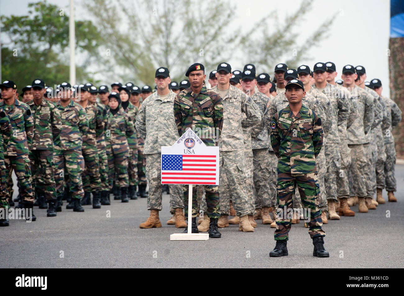 Armed forces members of the U.S. and Malaysia stand in formation during the Exercise Keris Aman 2015 opening ceremony held at the Segenting Camp’s Army Academy Parade Ground, Aug. 11, in Port Dickson, Malaysia. Keris Aman is a multinational training event co-hosted by the Malaysian Armed Forces and U.S. Pacific Command with representatives from 29 nations participating. Training events and exercises such as Keris Aman contribute to regional peacekeeping training capacity and strengthen multinational cooperation in global missions. (U.S. Air Force photo by Staff Sgt. Christopher Hubenthal) Exer Stock Photo