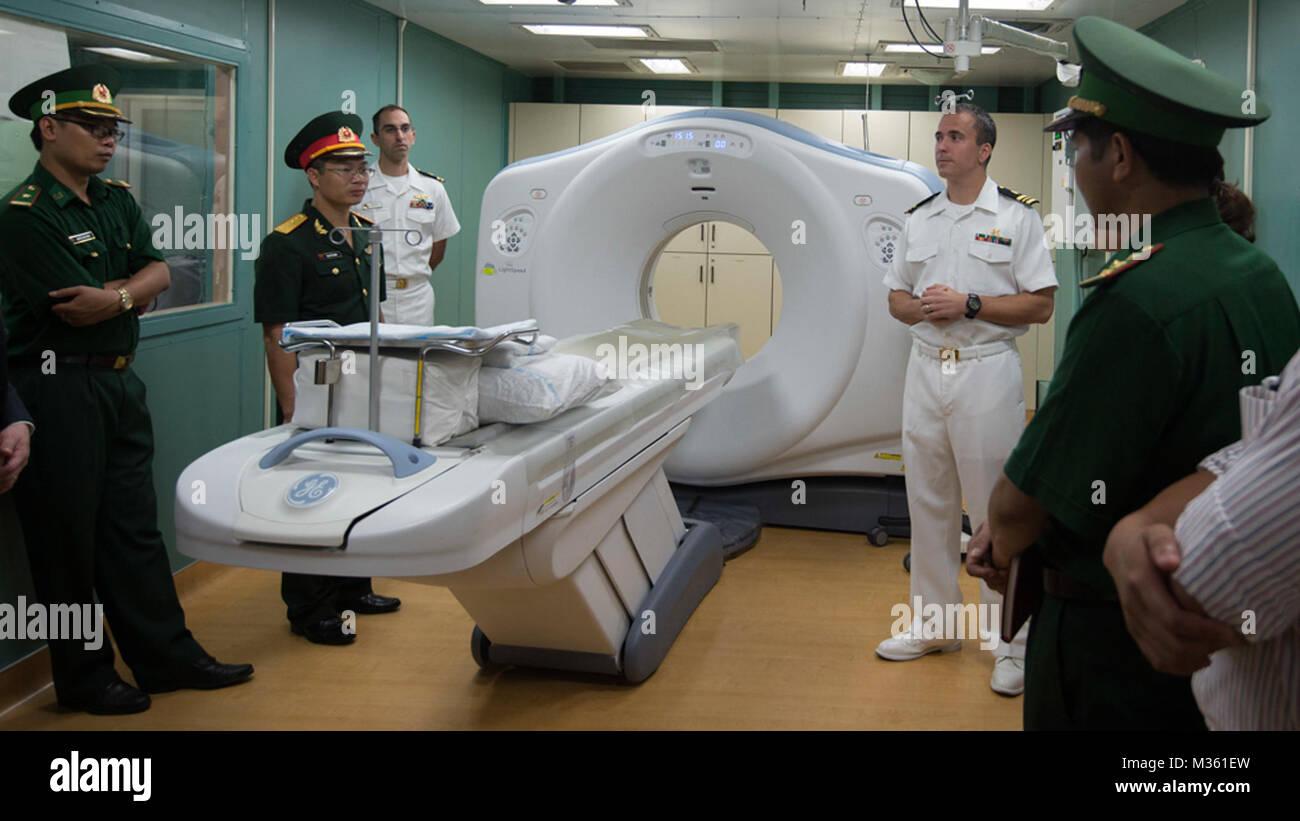 DA NANG, Vietnam (Aug. 17, 2015) Lt. Cmdr. Ryan Rockhill (right) gives a tour of the hospital ship USNS Mercy (T-AH 19) to distinguished visitors during Pacific Partnership 2015. Mercy is in Vietnam for its fourth mission port of PP15. Pacific Partnership is in its 10th iteration and is the largest annual multilateral humanitarian assistance and disaster relief preparedness mission conducted in the Indo-Asia-Pacific region. While training for crisis conditions, Pacific Partnership missions to date have provided medical care to approximately 270,000 patients and veterinary services to more than Stock Photo
