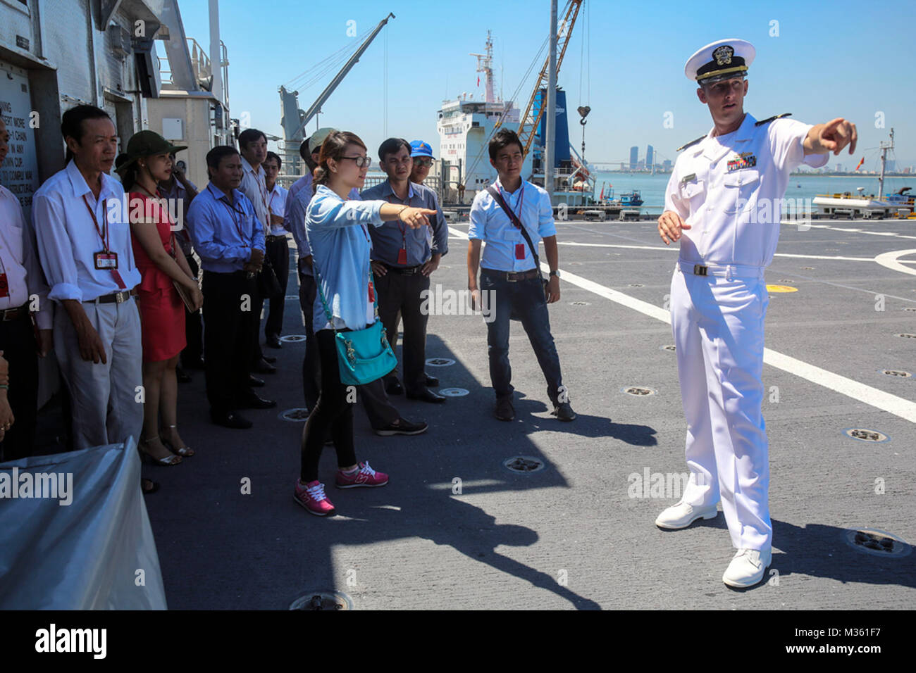 150818-M-GO800-062 DA NANG, Vietnam (Aug. 18, 2015) – Lt. j.g. Mark Roach explains to local Vietnamese officials the function of the flight deck aboard the Military Sealift Command joint high speed vessel USNS Millinocket (JHSV 3) during a ship tour Aug. 18. Task Force Forager, embarked aboard the Millinocket  is serving as the secondary platform for Pacific Partnership, led by an expeditionary command element from the Navy’s 30th Naval Construction Regiment (30 NCR) from Port Hueneme, Calif. Now in its 10th iteration, Pacific Partnership is the largest annual multilateral humanitarian assista Stock Photo