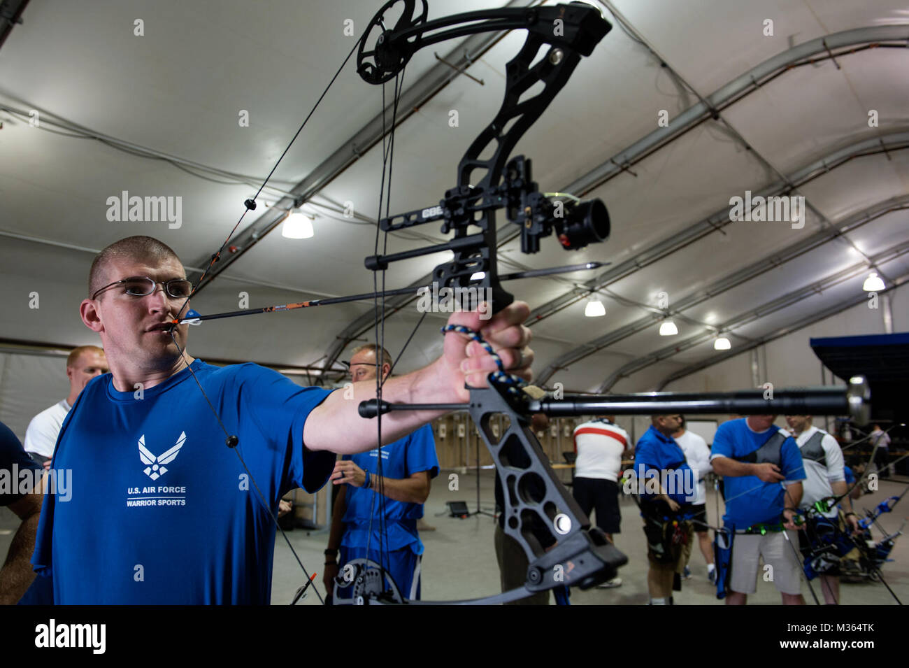 Retired Tech. Sgt. Matthew Hiniker, wounded warrior, pulls back an arrow with a bite tab during an adaptive archery class as part of the Air Force Wounded Warrior (AFW2) Program Warrior Care event Aug. 27, 2015, at Joint Base Lewis-McChord, Wash. The Warrior Care event features adaptive and rehabilitative sports activities, career readiness, recovering Airman mentorship and caregiver training. (U.S. Air Force photo by Staff Sgt. Ashley Hyatt/Released) 150827-F-WH920-011 by Air Force Wounded Warrior Stock Photo