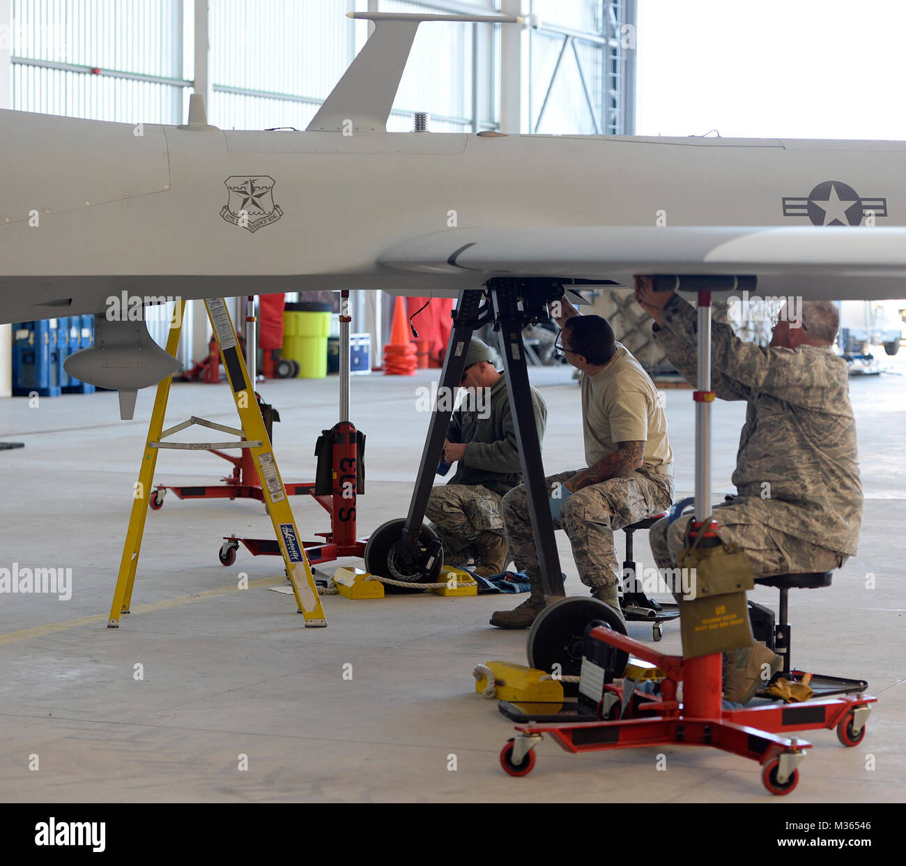 Maintainers with the 147th Maintenance Group, 147th Reconnaissance Wing, Texas Air National Guard, disassemble an MQ-1 Predator Sept. 11, 2015, at Lielvarde Air Base, Latvia. The airmen mobilized to the Baltic nation where they deployed an entire MQ-1B Predator package, launching and recovering the first large-scale remotely piloted aircraft in Latvia. (Air National Guard photo by 1st Lt. Alicia Lacy) 150911-Z-NC104-126 by Texas Military Department Stock Photo