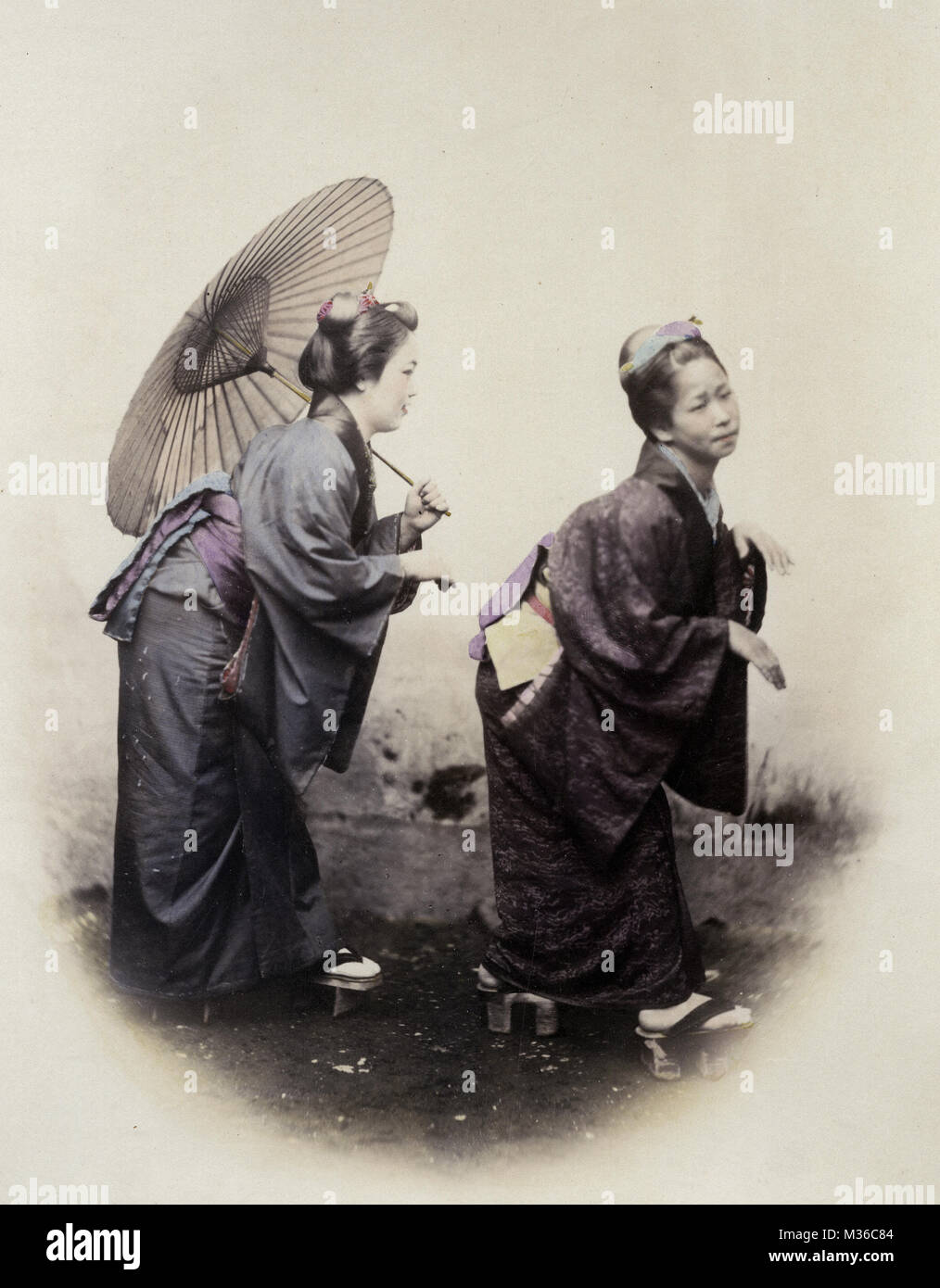 1860's Japan - portrait of a two young women in the pose of the Grecian Bend Stock Photo