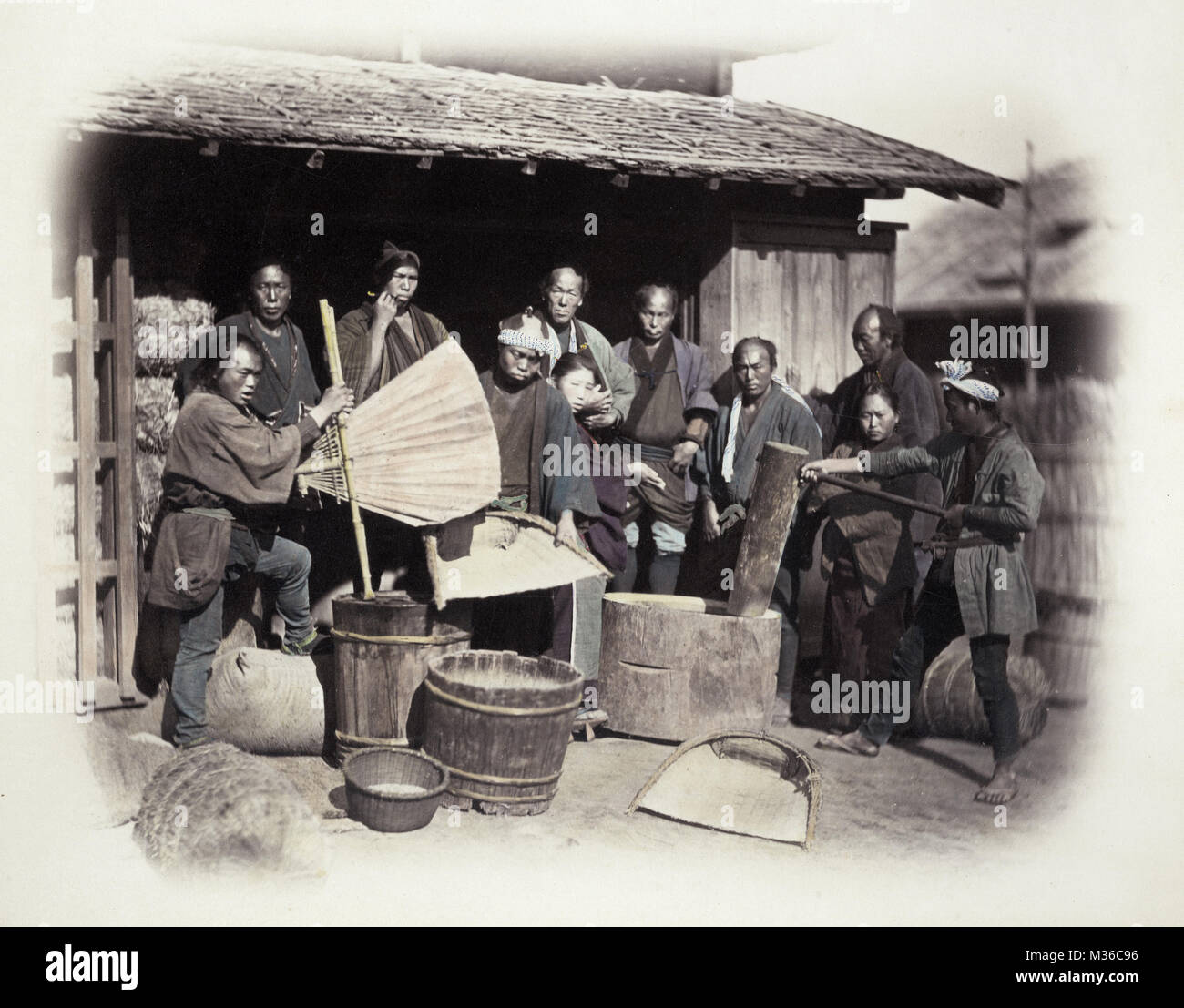1860's Japan - portrait of a group pounding rice Stock Photo