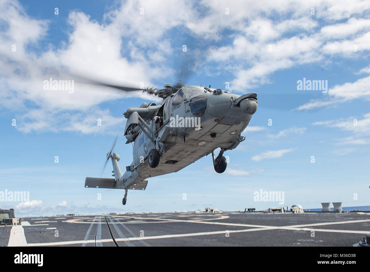 160620-N-WM647-110  PHILLIPINE SEA (June 20, 2016) An MH-60S Sea Hawk helicopter, assigned to the “Golden Falcons” of Helicopter Sea Combat Squadron (HSC) 12, takes off from the flight deck of the Arleigh-Burke class guided-missile destroyer USS McCampbell (DDG 85). McCampbell is on patrol with the Carrier Strike Group Five (CSG 5) in the U.S. 7th Fleet area of responsibility supporting security and stability in the Indo-Asia-Pacific. (U.S. Navy photo by Mass Communication Specialist 3rd Class Elesia K. Patten/Released) Flight ops on USS McCampbell during Carrier Strike Group Five (CSG 5) patr Stock Photo