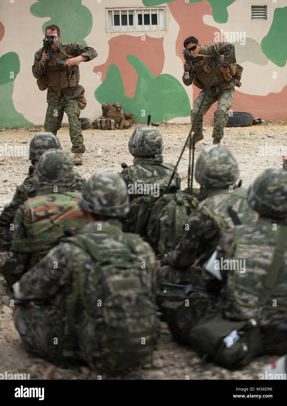 U.S. Marines demonstrate the speed reload in front of a formation of Republic of Korea Marines, June 28, 2016, at Suseong Range, South Korea, during a Korean Marine Exchange Program 16-11. The goal of the KMEP is to sustain the combined force and enhance the ROK-U.S. team at the tactical level to build combined warfighting capabilities. The U.S. Marines were a part of Fox Company, 2nd Battalion, 2nd Marine Regiment, 2nd Marine Division, currently assigned to 4th Marine Regiment, III Marine Expeditionary Force under the Unit Deployment Program. The ROK Marines were a part of 73rd Battalion, 7th Stock Photo