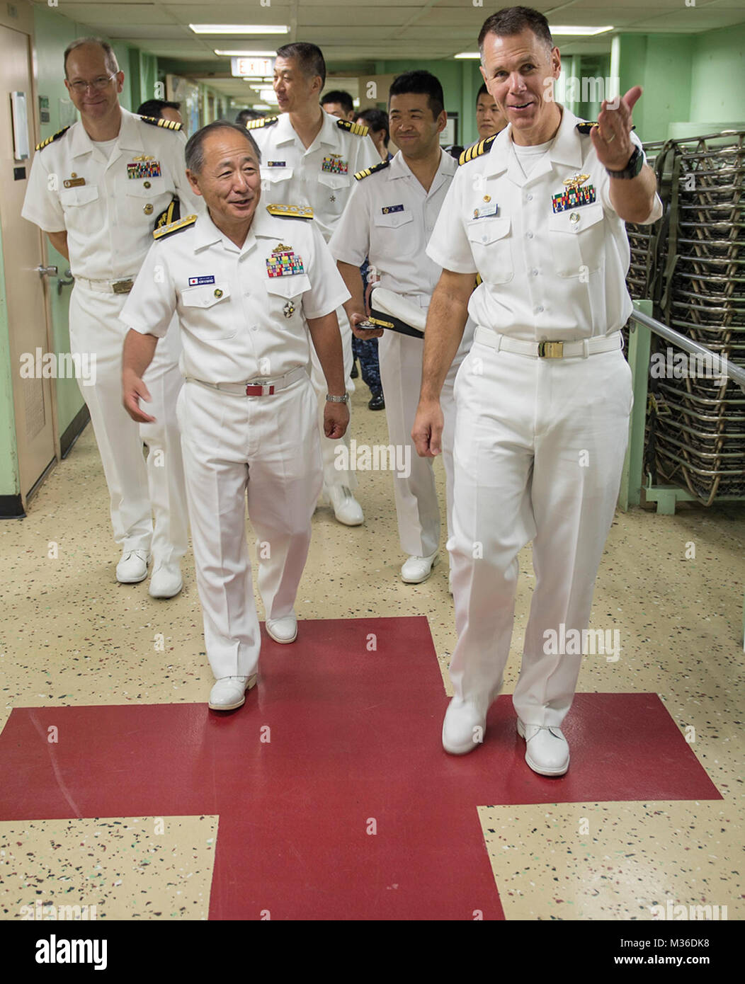 160717-N-QW941-239  DA NANG, Vietnam (July 17, 2016) U.S. Navy Capt. Peter Roberts (right), commanding officer, Medical Treatment Facility, USNS Mercy (T-AH 19), guides Admiral Katsutoshi Kawano (left), chief of staff of the Joint Staff, Japanese Self-Defense Force, during a tour of the ship. Kawano visited Mercy and JS Shimokita (LST-4002), which are both in Da Nang for Pacific Partnership 2016. Partner nations are working side-by-side with local military and non-government organizations to conduct cooperative health engagements, community relation events and subject matter expert exchanges t Stock Photo