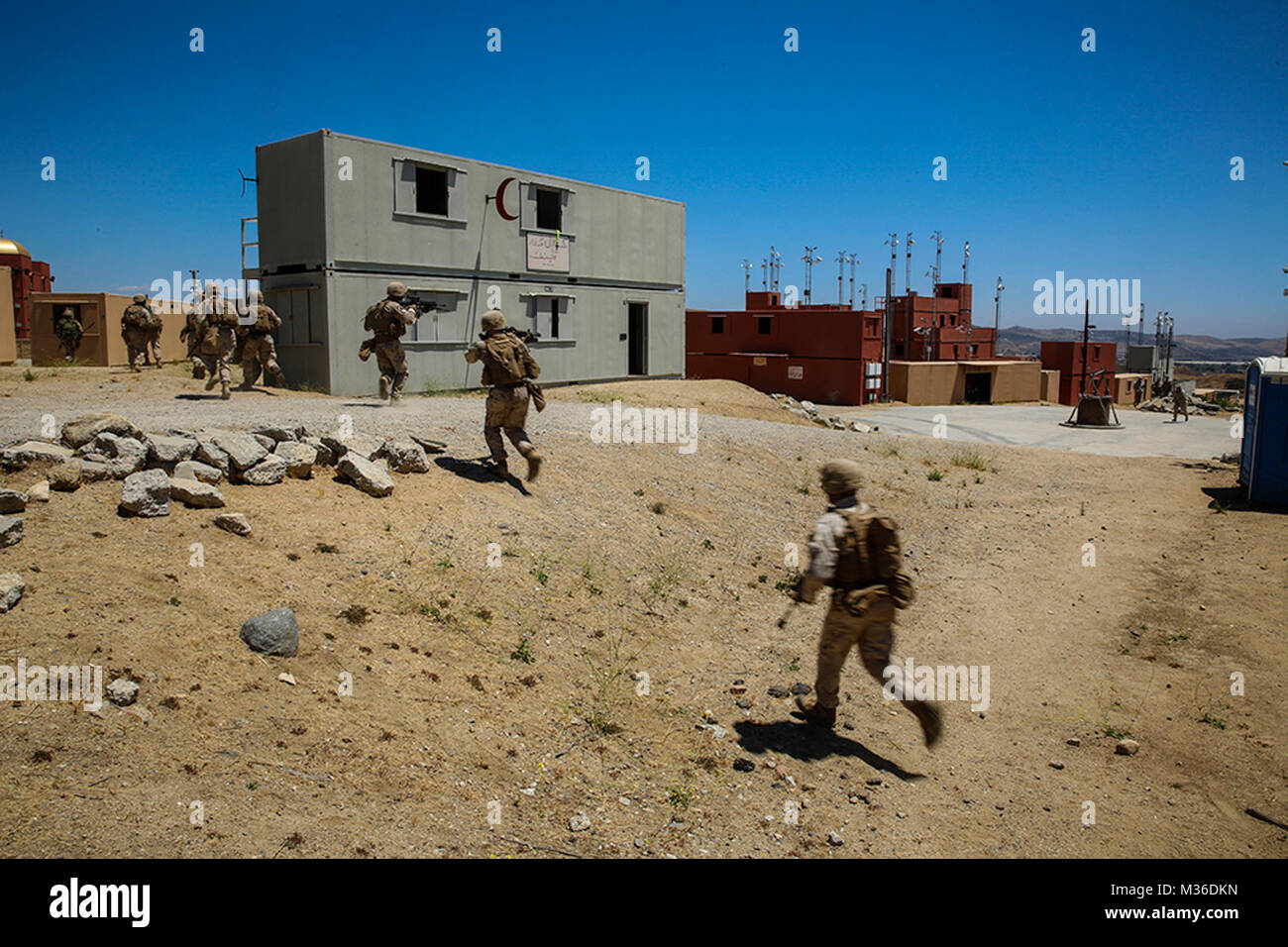 MARINE CORPS BASE CAMP PENDLETON, California, (July 19, 2016), -- U.S. Marines move to a secure position while responding to simulated enemy fire during military operations on urban terrain training aboard Camp Pendleton, July 19, 2016. The training was conducted with U.S., Chilean, and Canadian service members to enhance interoperability between partner nations. Twenty-six nations, more than 40 ships and submarines, more than 200 aircraft and 25,000 personnel are participating in RIMPAC from June 30 to Aug. 4, in and around the Hawaiian Islands and Southern California. The world's largest int Stock Photo