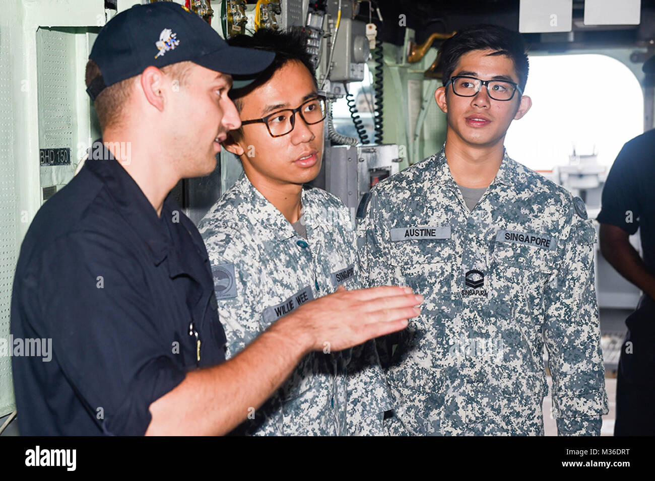 160726-N-YS140-048 SOUTH CHINA SEA (July 26, 2016) Republic of Singapore (RSN) sailors Lt. Willie Wee and Cpl. Austine Yapp are briefed by Ens. Drew Boyer aboard the Arleigh Burke-class guided missile-destroyer USS Stethem (DDG 63) as part of a sailor exchange during Cooperation Afloat Readiness and Training (CARAT) Singapore 2016, July 26. CARAT is a series of annual maritime exercises between the U.S. Navy, U.S. Marine Corps and the armed forces of nine partner nations to include Bangladesh, Brunei, Cambodia, Indonesia, Malaysia, the Philippines, Singapore, Thailand, and Timor-Leste. (U.S. N Stock Photo