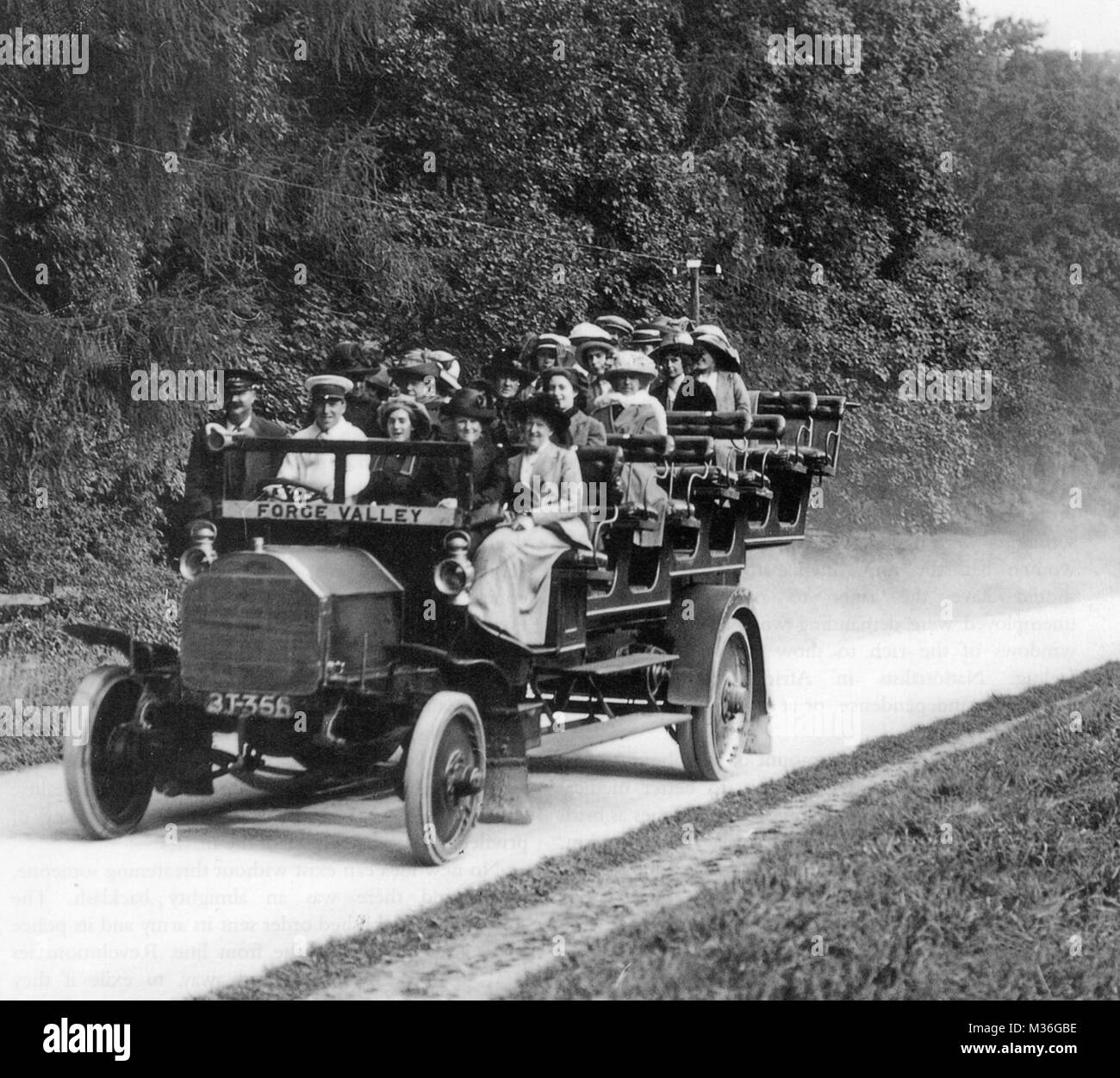 CHARABANC  A smartly dressed group of women riding an open motor coach on a sunny day between Scarborough and Pickering in Yorkshire in 1913 Stock Photo