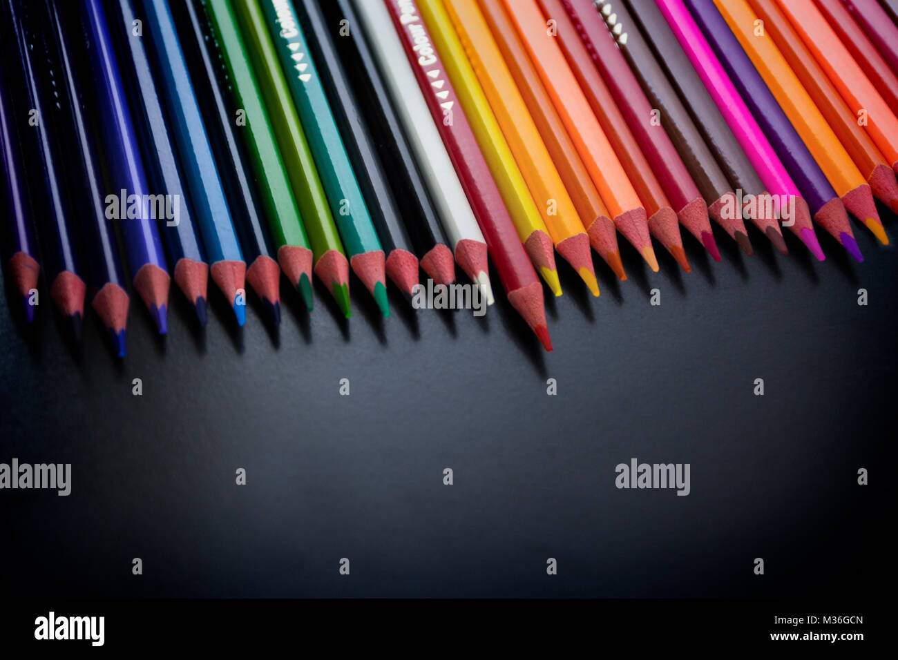 Pattern of color pencils isolated on Black background close up Stock Photo