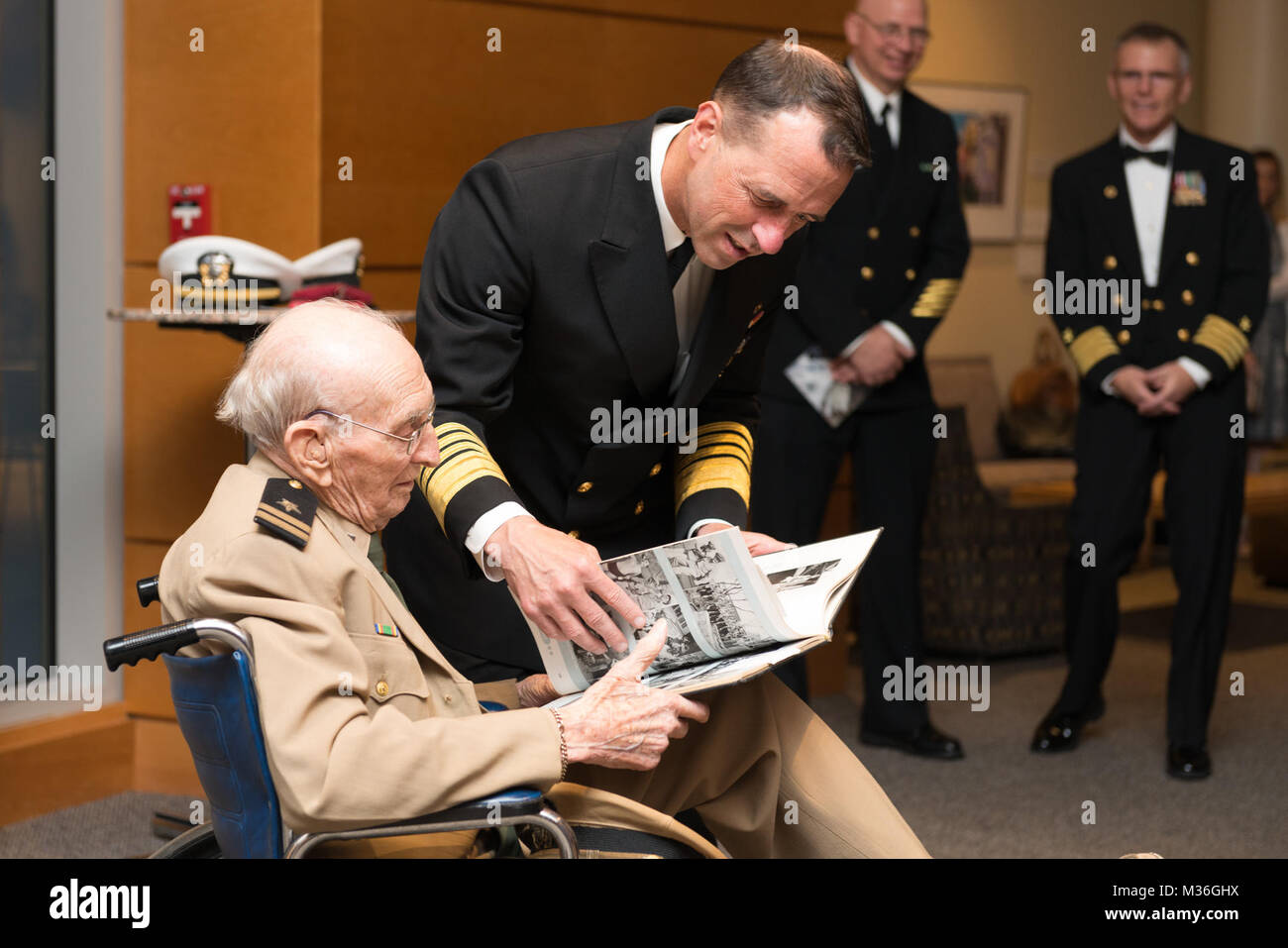 161005-N-DD694-444 BETHESDA, Md. (Oct. 5, 2016) Chief of Naval Operations Admiral John Richardson presents a cruise book to World War II veteran Norton Hurd after the Navy Birthday Concert. The Navy Band was celebrating the Navy's 241st birthday. (U.S. Navy photo by PO1 Jonathan Barnes/Released) 161005-N-DD694-444 by United States Navy Band Stock Photo