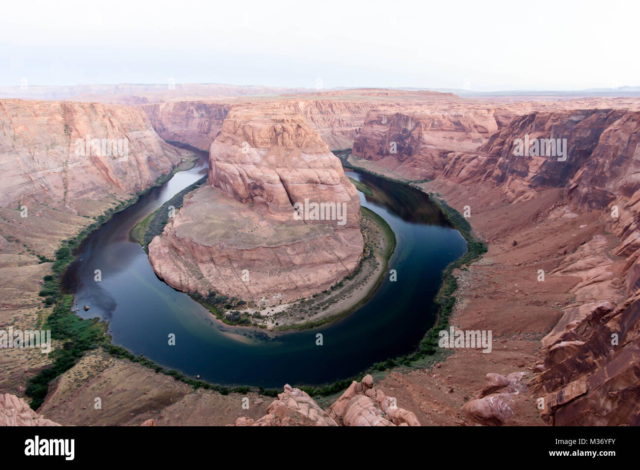 early morning at Horseshoe Bend with a boat moving up the river Stock