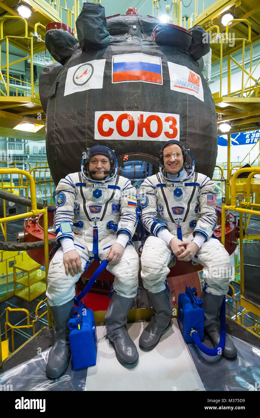 In the Integration Building at the Baikonur Cosmodrome in Kazakhstan, Expedition 51 crew members Fyodor Yurchikhin of the Russian Federal Space Agency (Roscosmos, left) and Jack Fischer of NASA (right) pose for pictures April 6, 2017 in front of their Soyuz MS-04 spacecraft as part of pre-launch training preparations. Fischer and Yurchikhin launched April 20 on the Soyuz MS-04 spacecraft for a four and a half month mission on the International Space Station. (photo/NASA/Gagarin Cosmonaut Training Center/Andrey Shelepin) jsc2017e040289orig by AirmanMagazine Stock Photo
