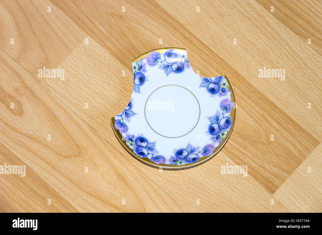 Broken china plate on the floor Stock Photo Alamy