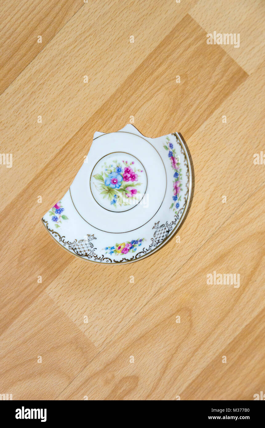 Broken china plate on the floor Stock Photo Alamy