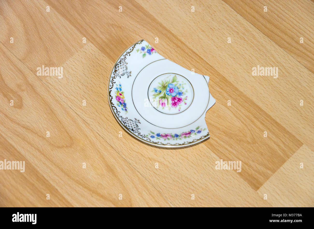 Broken china plate on the floor Stock Photo Alamy