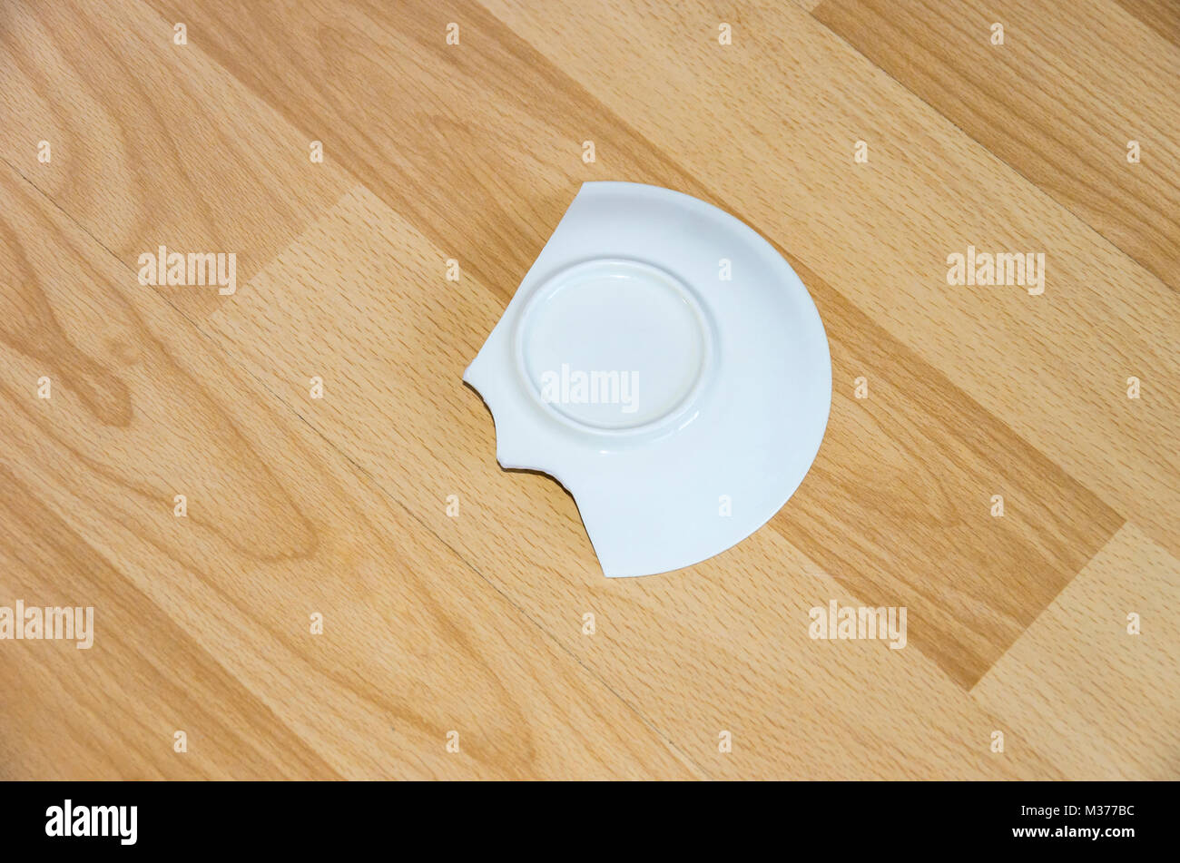 Broken china plate on the floor Stock Photo Alamy