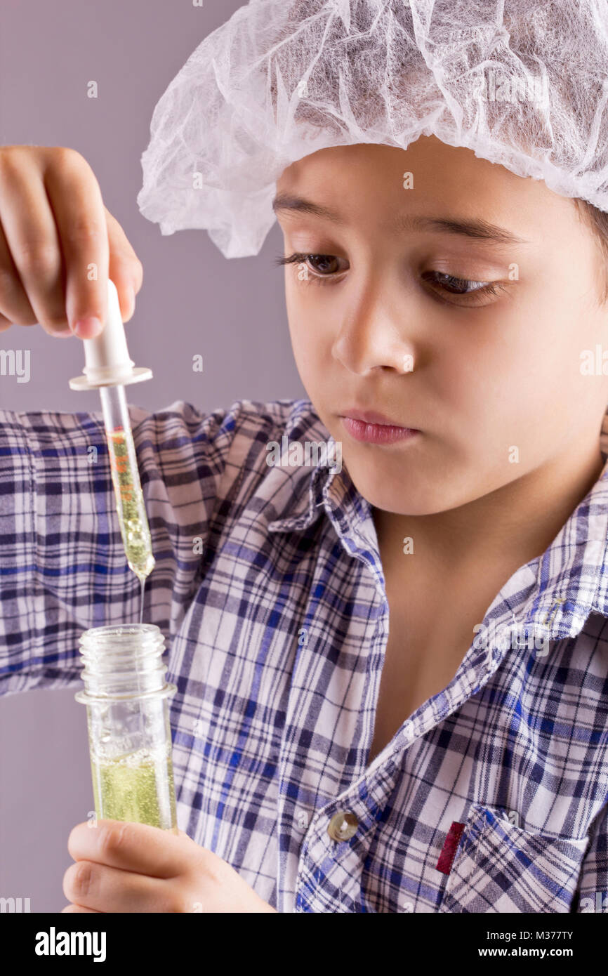 little scientist exercise  chemistry and uses a pipette and tube Stock Photo