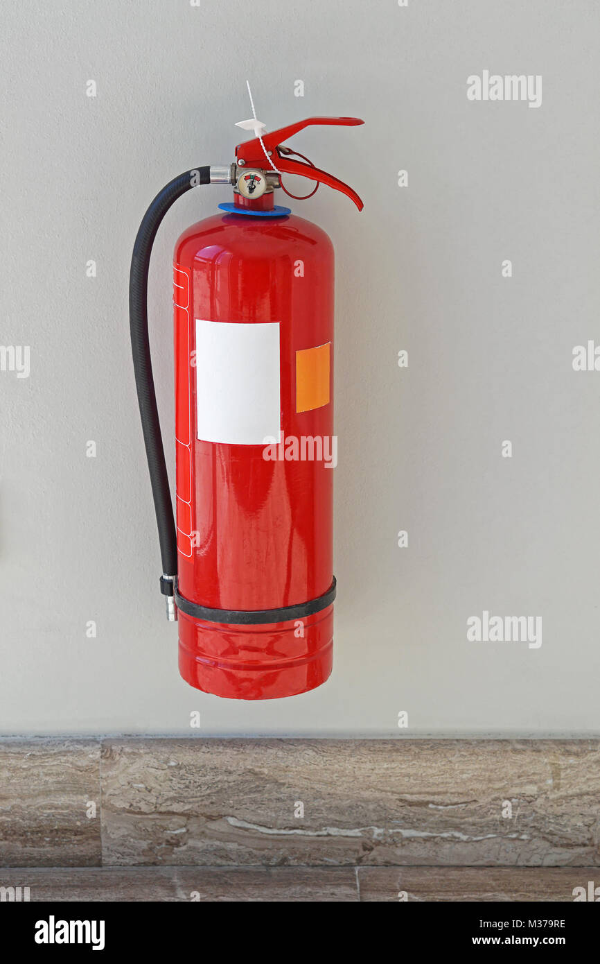 Fire extinguisher protection device at wall Stock Photo - Alamy
