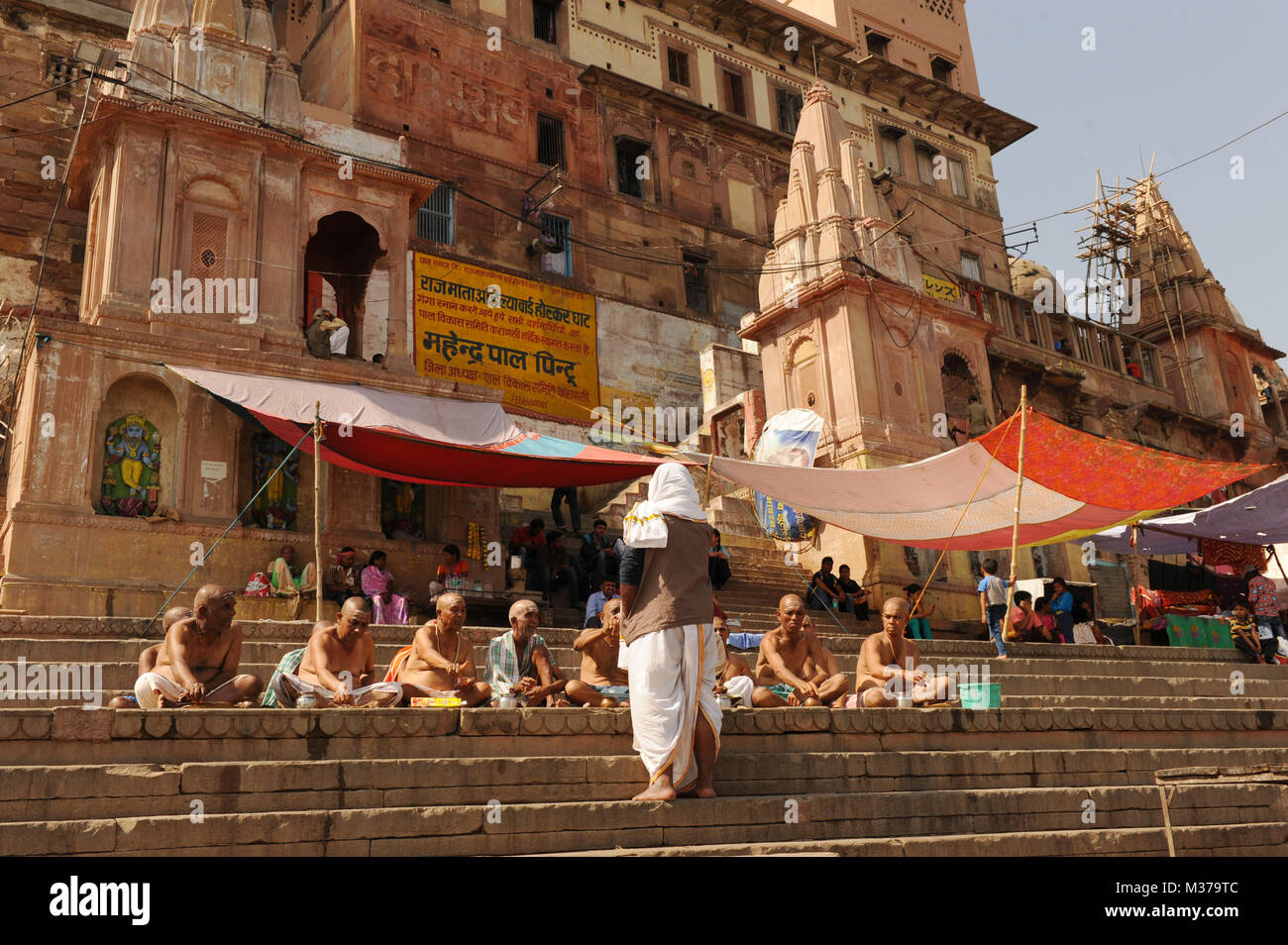 Holymen sit on steps in Varanasi, India Stock Photo