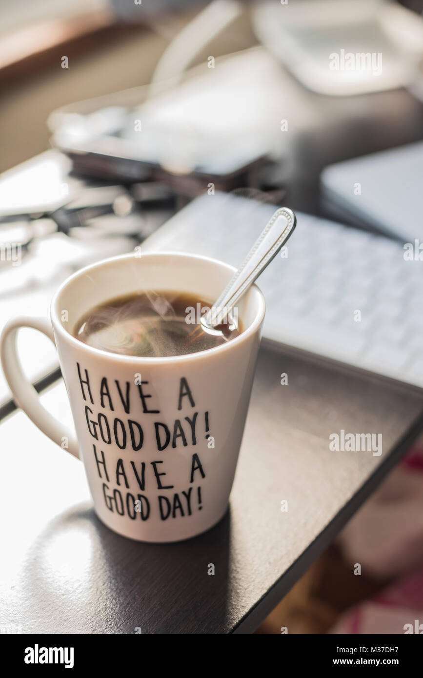morning coffee in a mug with message &ldquo;have a good day&rdquo; on a blury