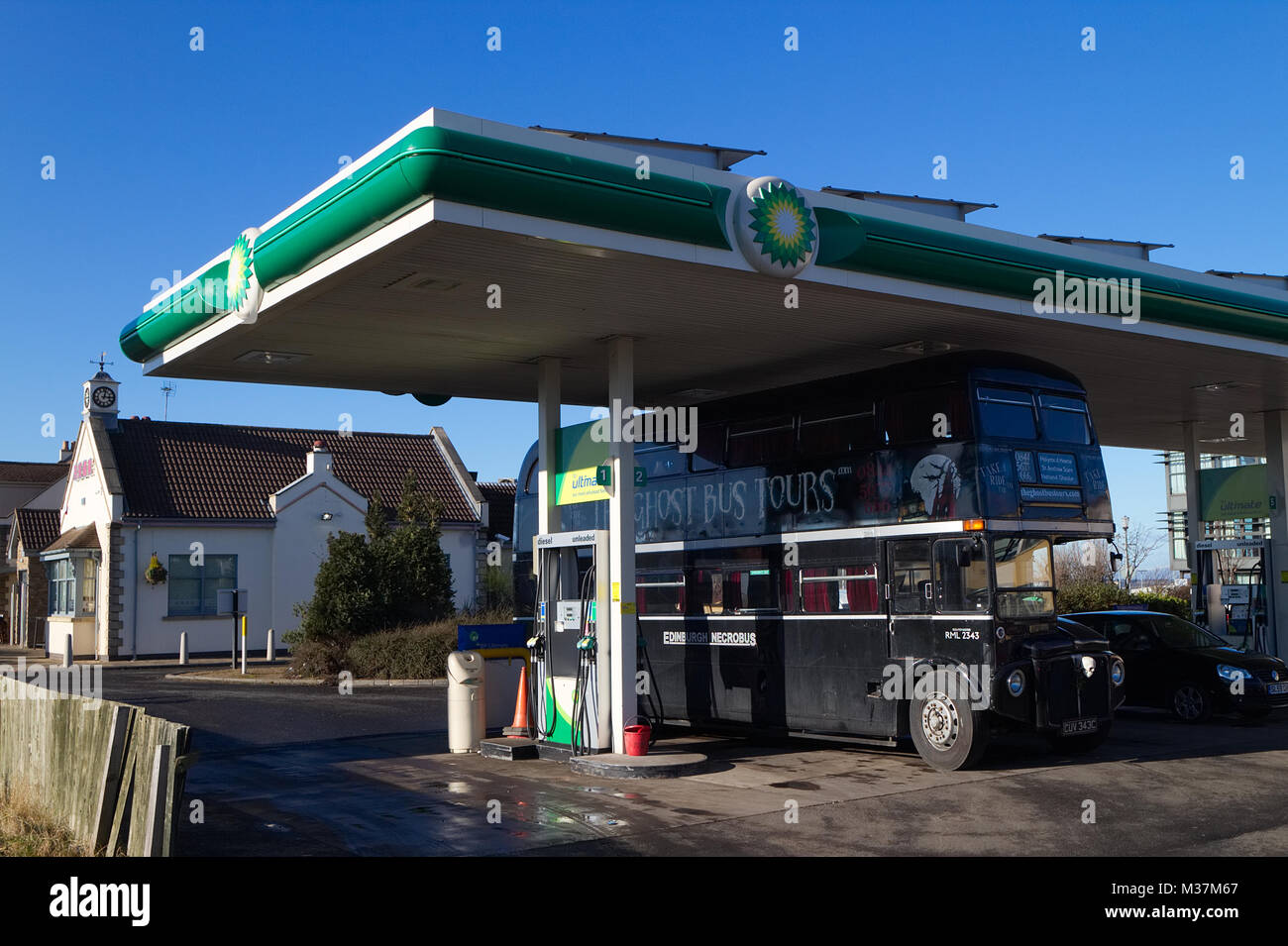 Edinburgh, Scotland / United Kingdom - February 09 2018: A photograph of the Edinburgh Ghost Bus Tour refuelling at a BP Petrol Station. Stock Photo