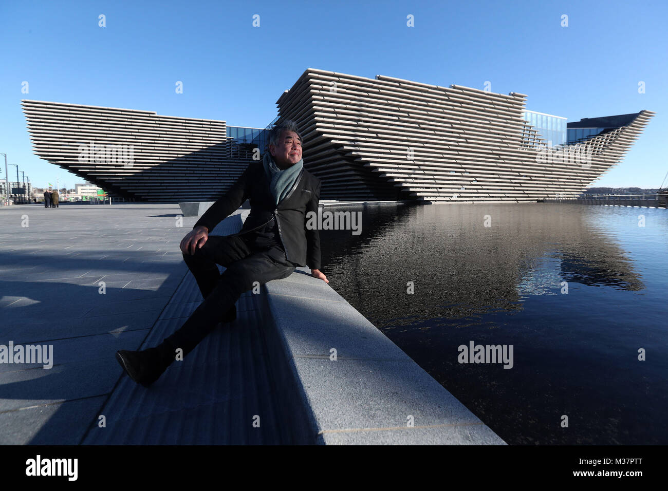 Japanese architect Kengo Kuma as he views the finished exterior of the new eighty million pound V&amp;A Dundee museum for the first time. The designer met workers as the focus moves to the interior of the V&amp;A, fitting out gallery spaces, a cafe and a restaurant ahead of its opening in September. Stock Photo