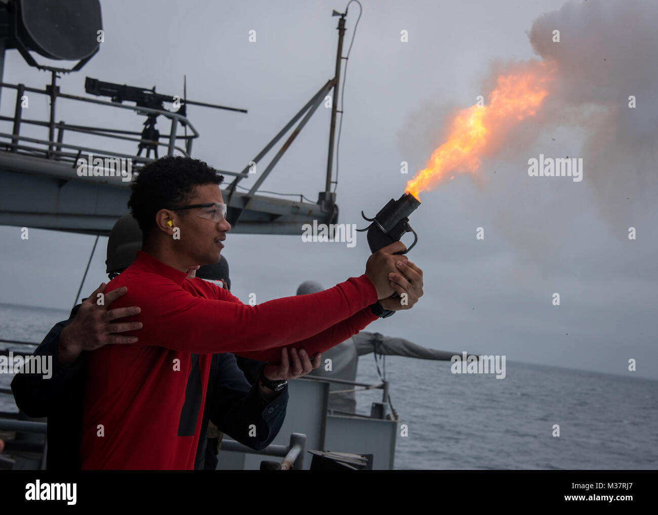 170605-N-LK571-833  PACIFIC OCEAN (June 5, 2017) Gunner’s Mate 2nd Class Deion Mahone, from  Indianapolis, fires a flare gun during a live-fire exercise in the western Pacific aboard the Nimitz-class aircraft carrier USS Carl Vinson (CVN 70). The U.S. Navy has patrolled the Indo-Asia-Pacific routinely for more than 70 years promoting regional peace and security. (U.S. Navy photo by Mass Communication Specialist 3rd Class Matthew Granito/Released) USS Carl Vinson Sailors conduct a live-fire exercise in the Western Pacific by #PACOM Stock Photo