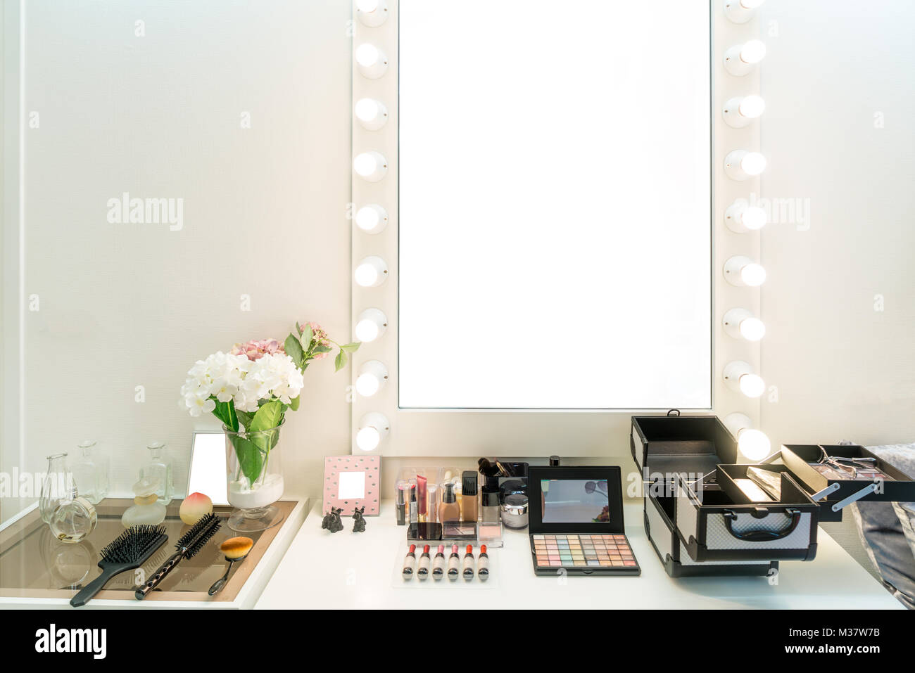 Modern closet room with make-up vanity table, mirror and cosmetics product in flat style house. Stock Photo