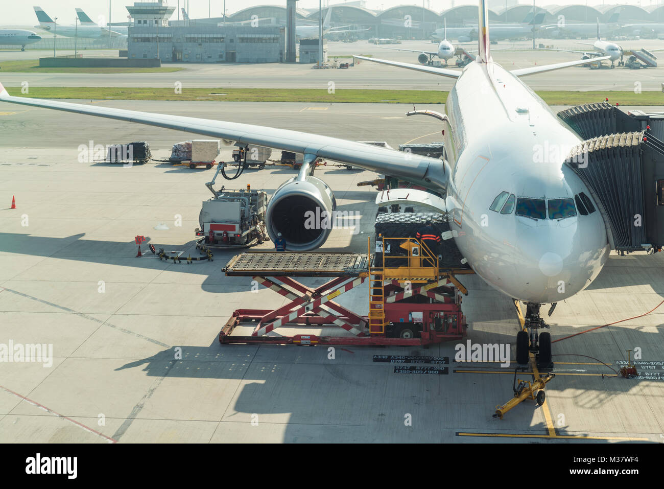 Loading cargo on plane in airport before flight. Stock Photo